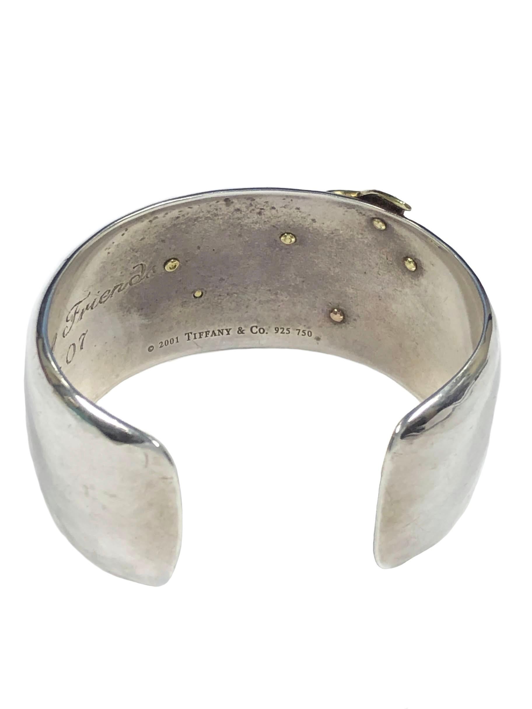 Circa 2005 Tiffany & Company Dragonfly Cuff Bracelet, Hand Hammered Sterling Silver and measuring 1 1/8 inch wide, applied, heavy and very detailed 18K Yellow and Rose Gold Dragonfly. Wrist size 6 inches with a 1 inch opening and is slightly