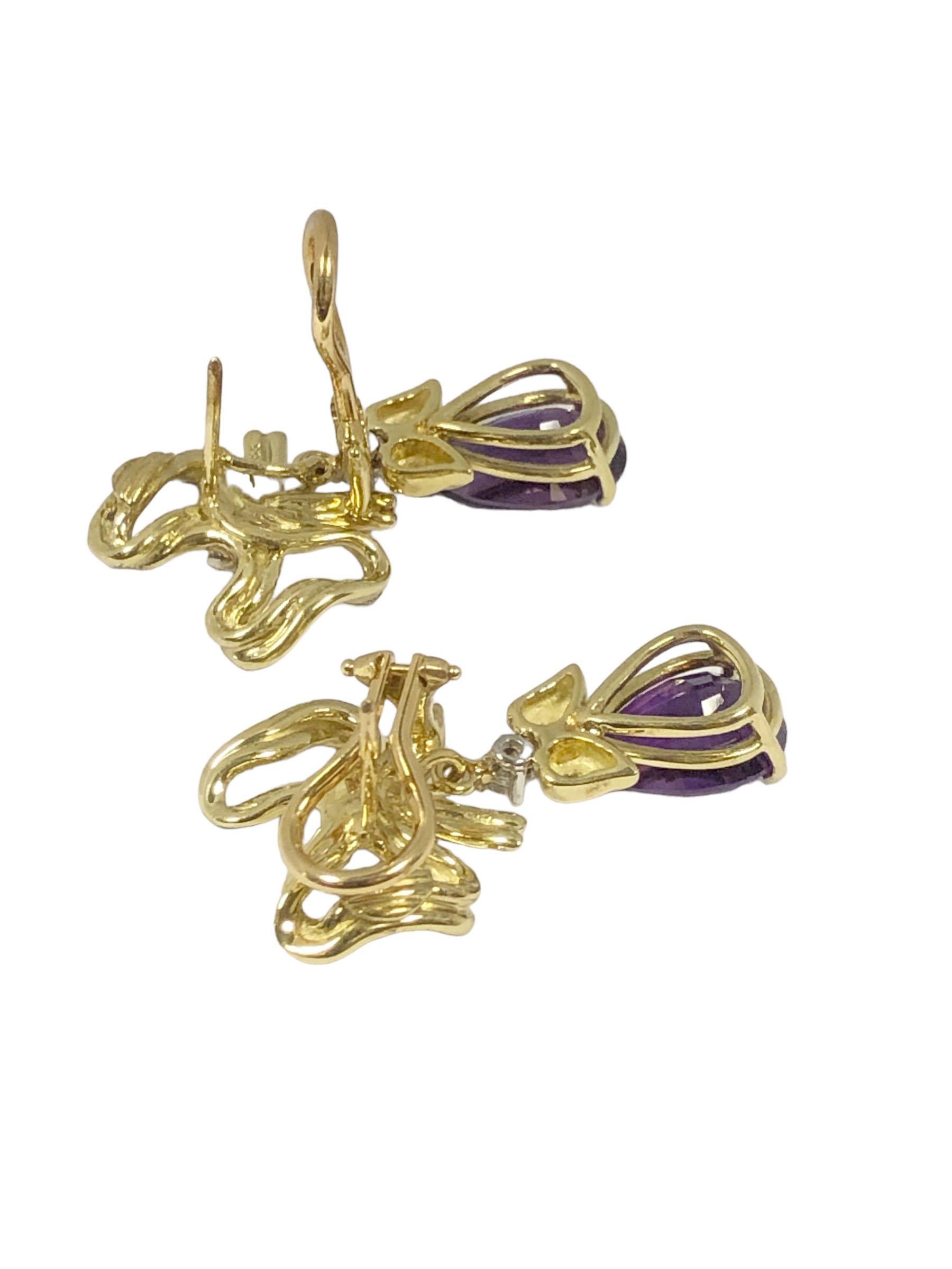 Circa 1990 Tiffany & Company 18k Yellow Gold Earrings, measuring 1 1/8 inches in length and 5/8 inch wide, in a Ribbon and Bow form with the bottom dangle Amethyst section being removable so the bow form tops can be worn alone. Set with Round