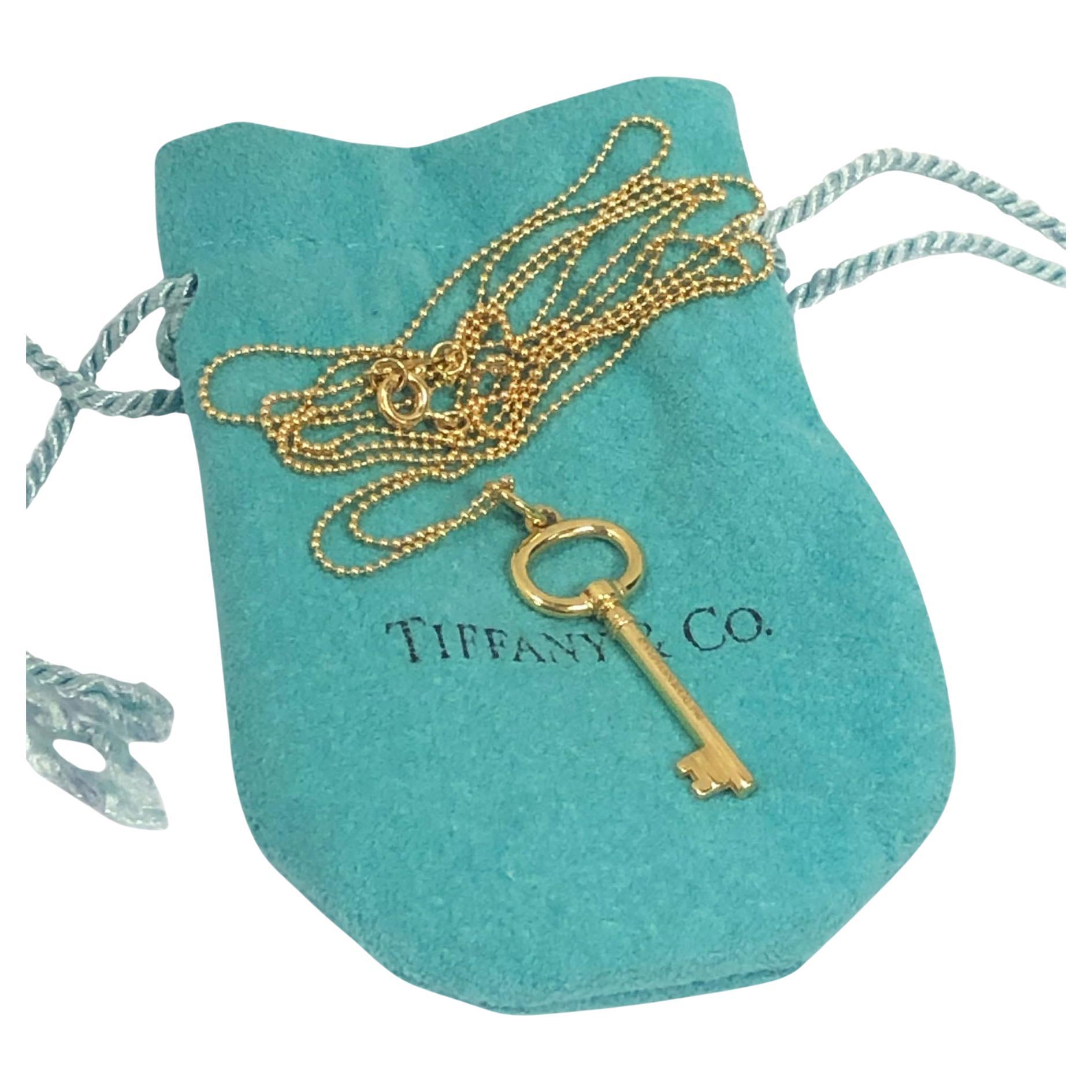 Tiffany 
Company Key Charm Pendant on 24 inch Bead Necklace For Sale