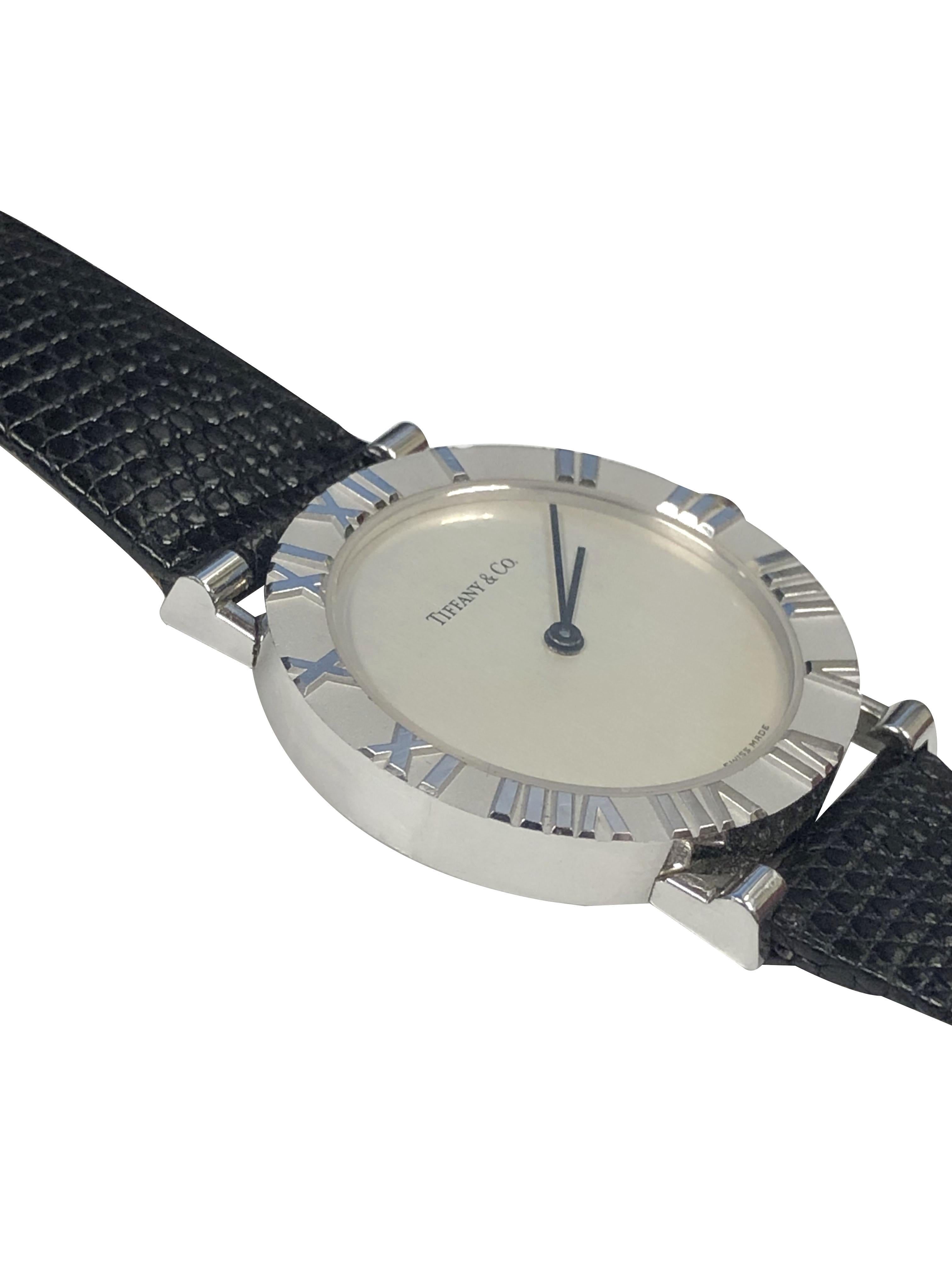 Circa 2010 Tiffany & Company Atlas collection Wrist Watch, 31 M.M. Sterling Silver 2 Piece Water Resistant Case with raised Roman Numerals. Quartz Movement, Silver Dial. New Black Lizard Strap, comes in original Tiffany Suede covered Presentation