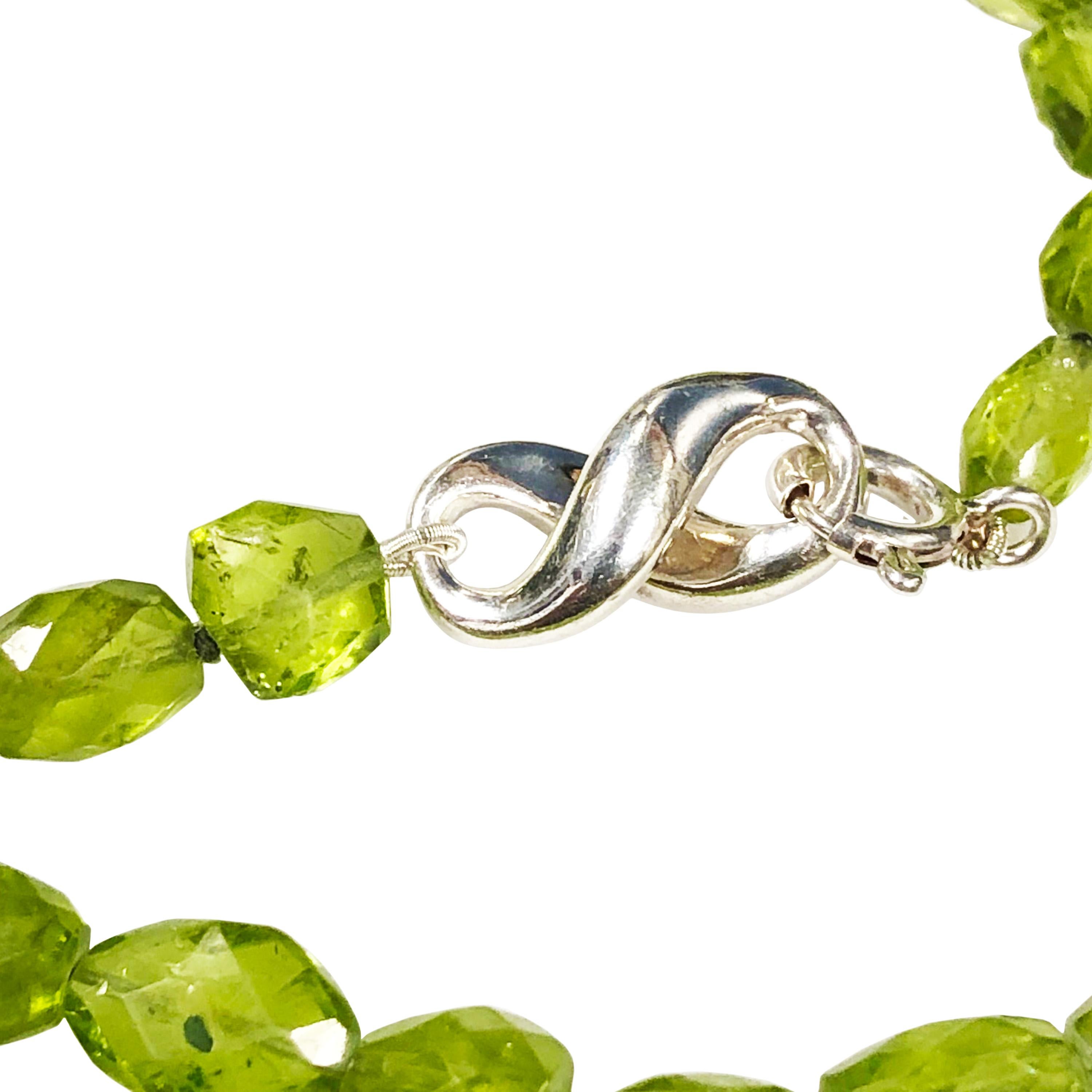 Circa 1999 Tiffany & Company 54 inch necklace comprised of faceted, graduated Peridot Beads measuring in size from 8 to 18 MM.  Sterling silver Signed Tiffany Clasp that is dated 1999. From a very limited produced collection, comes in the original