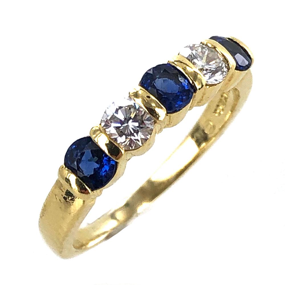 Stunning diamond and sapphire band by Tiffany & Co. The band features 2 round brilliant cut diamonds graded F color and VS1 clarity, and 3 round blue natural sapphires. The ring is currently size 7.75. Signed Tiffany & Co. 750. Weight: 4.1 grams.