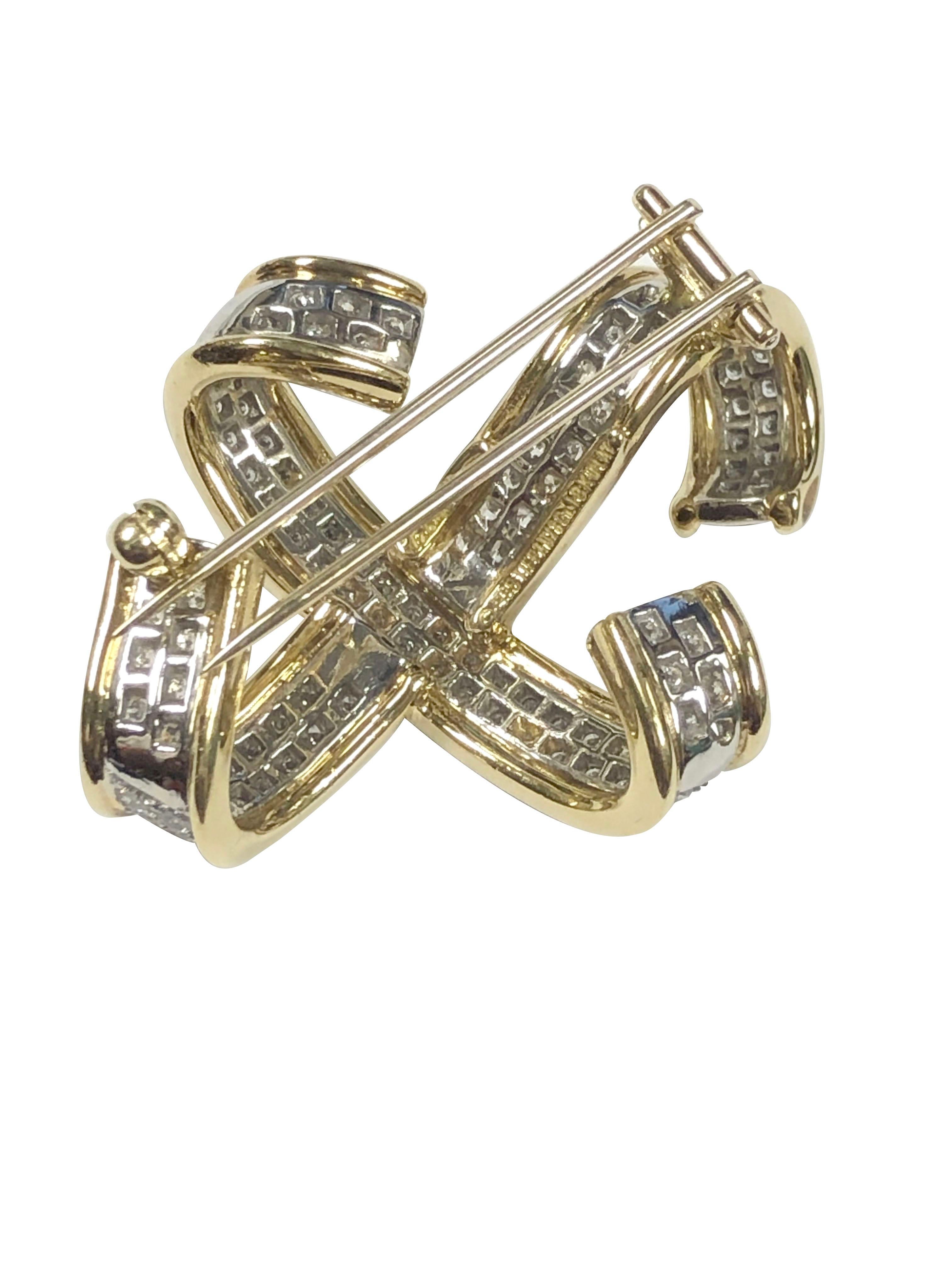 Circa 1989 Paloma Picasso for Tiffany & Company 18k Yellow Gold X brooch. Measuring 1 1/2 inches in length X 1 inch, having a double clip pin fastener, set with 2 Carats of Fine White Round Brilliant cut Diamonds.
