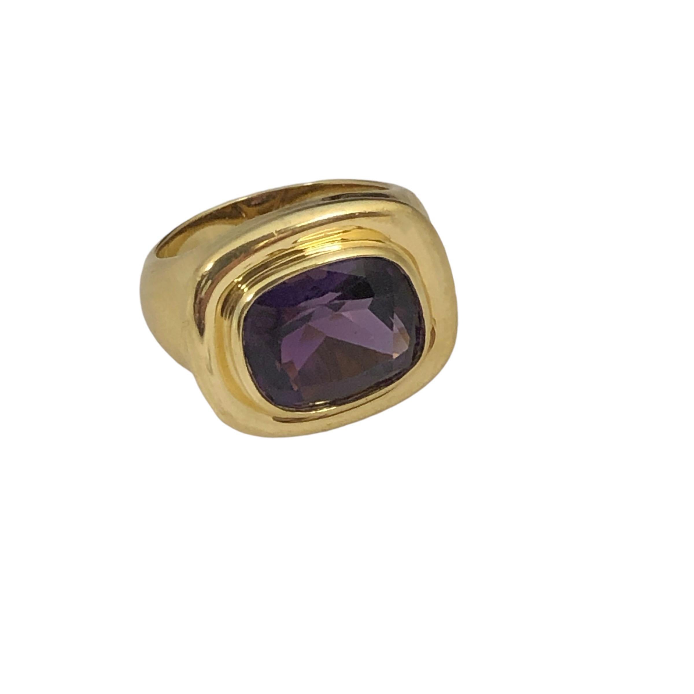 Circa 1990s Paloma Picasso for Tiffany & Company 18k Yellow Gold Ring, the top measures 3/4 x 5/8 inch and is set with an elongated Cushion cut Depp Purple Amethyst of approximately 4 to 5 Carats. Finger size 6 1/2 and weighing 15 Grams. Comes in a