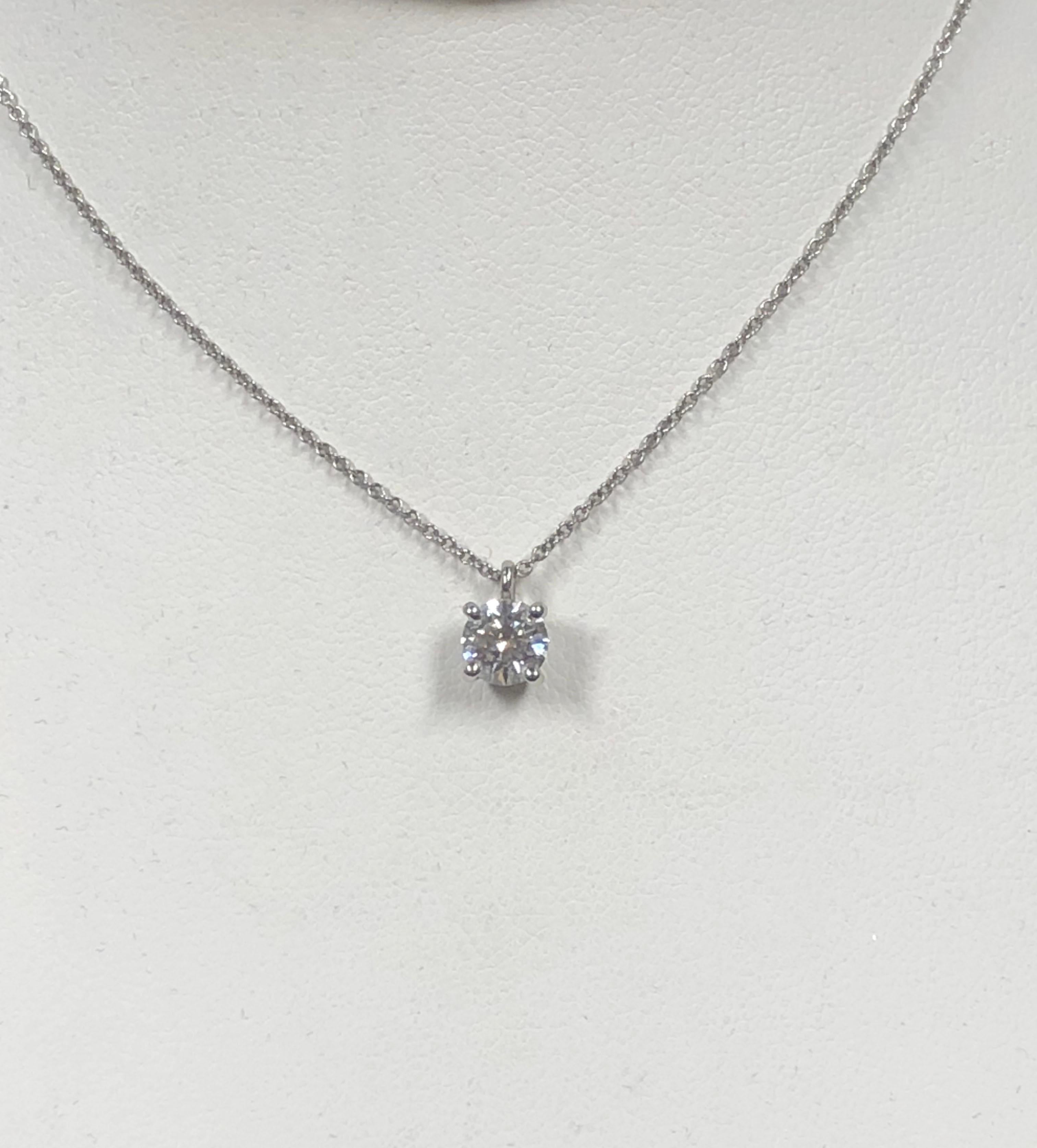 Circa 2010 Tiffany & Company Diamond Solitaire Pendant Necklace, suspended from a 16 inch Platinum chain, a Platinum 4 prong mount holds a .61 Carat Round Brilliant cut Diamond that is G in color and VS in clarity, comes in the original Tiffany