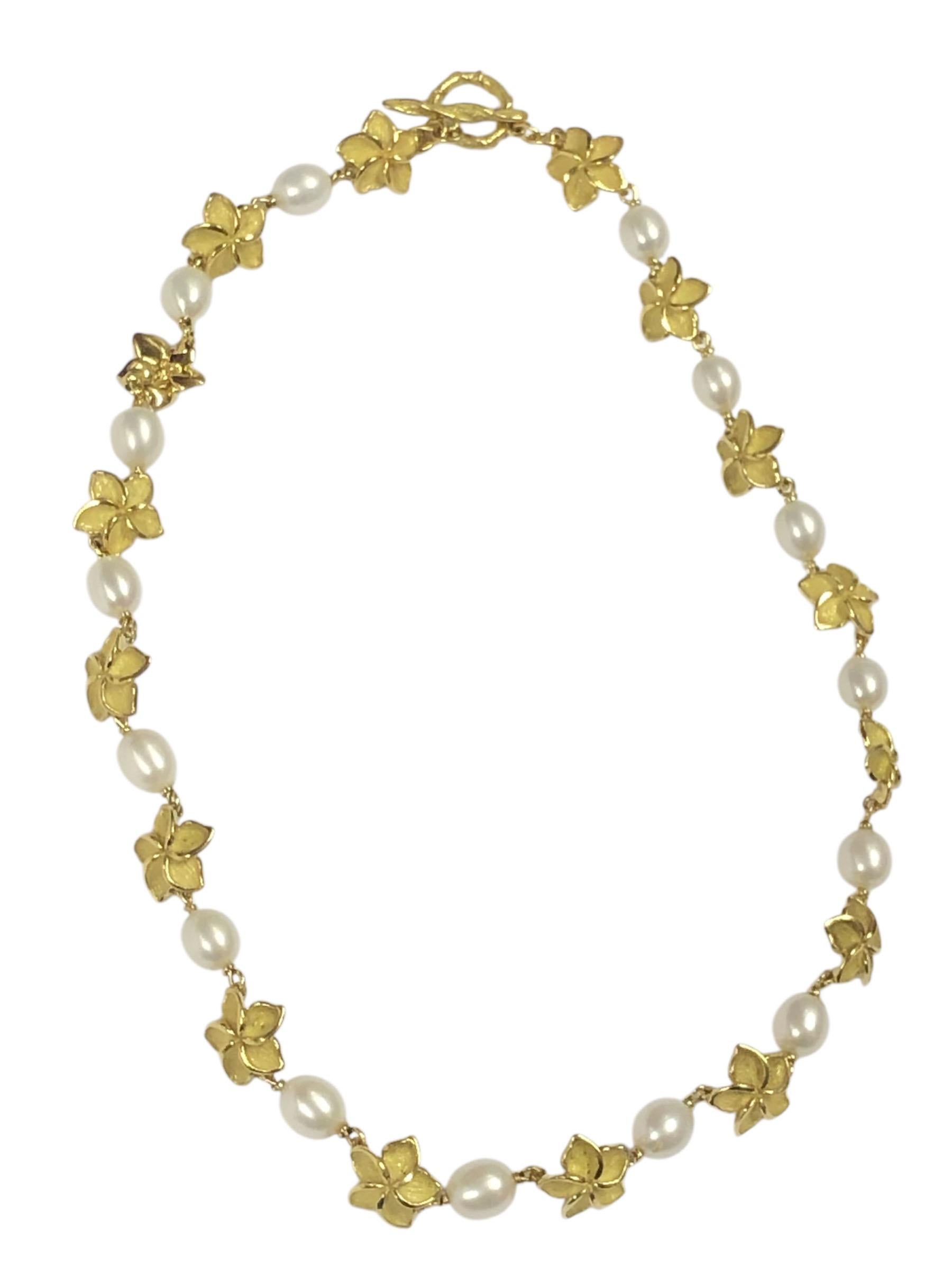 Circa 2020 Tiffany & Company Plumeria collection Necklace, measuring 16 inches in length and comprising alternating 18k Yellow Gold Textured Flowers and 8 x 6 M.M. oval Cultured Pearls. Toggle clasp. Comes in Tiffany Suede necklace wrap in box.