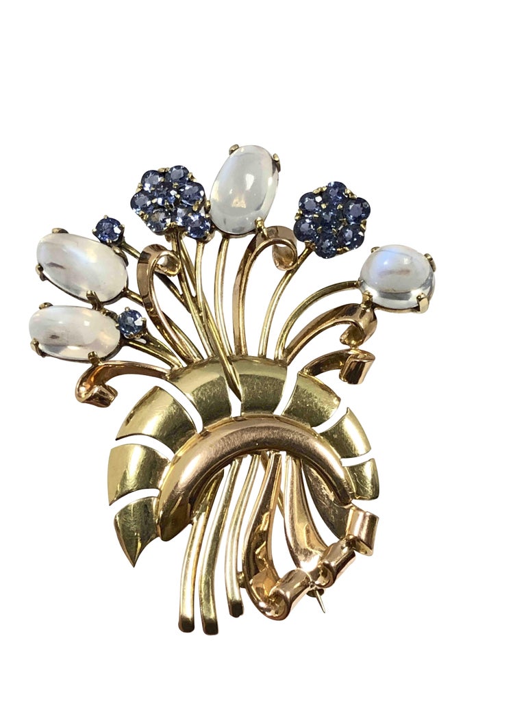Circa 1940 Tiffany & Company 14K Rose and Green Gold flowers form Brooch in a very Retro Period style, measuring 2 3/8 inches in length and 2 inches wide. Set with very fine color Moonstones and Sapphires that are possibly Montana in origin. 