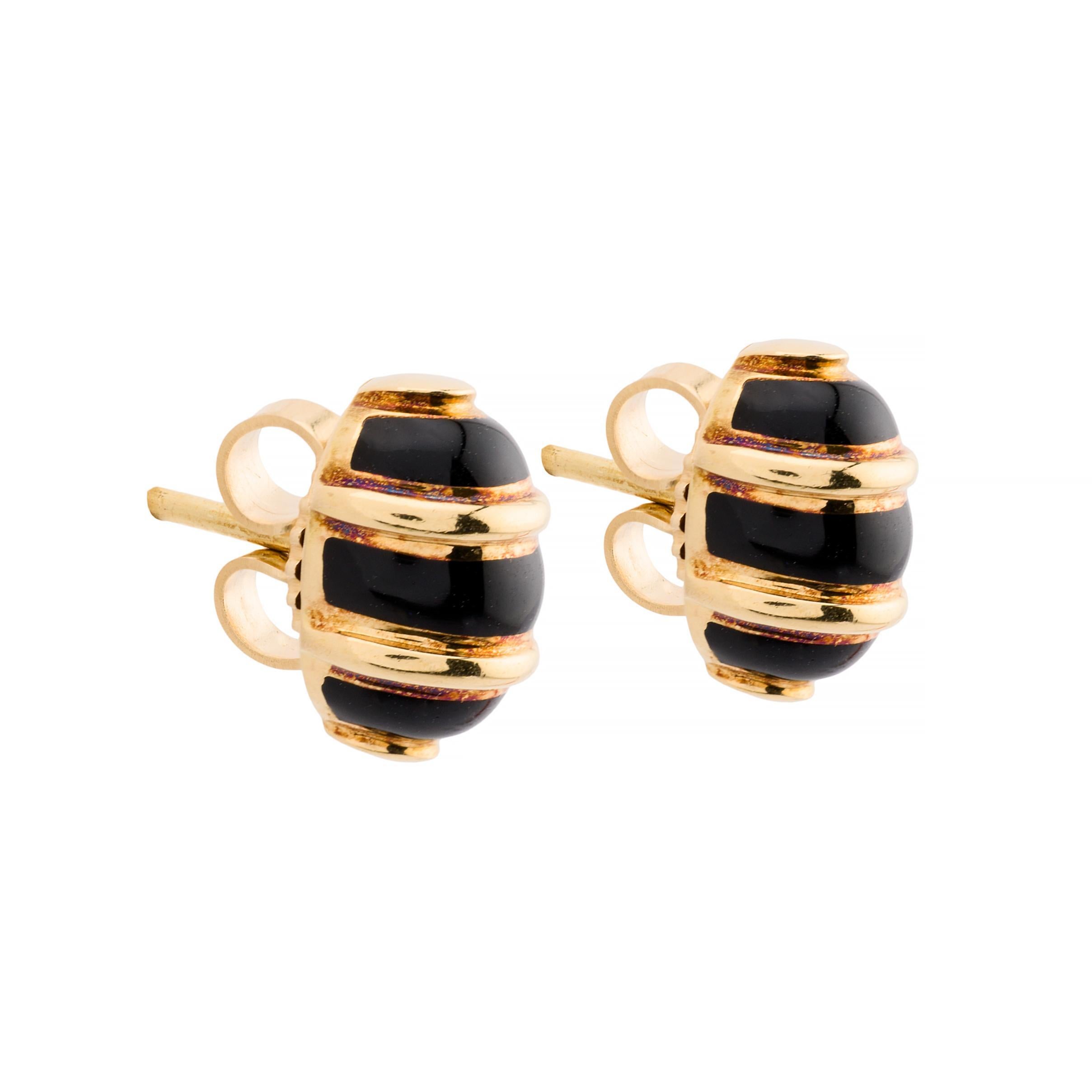 Aston Estate Jewelry Presents:

Elegant Tiffany & Company stud earrings crafted in 18k yellow gold and enamel.   Each earring features a striking black enamel design, accented with gold bands that wrap around the oval shape. Designed by the renowned