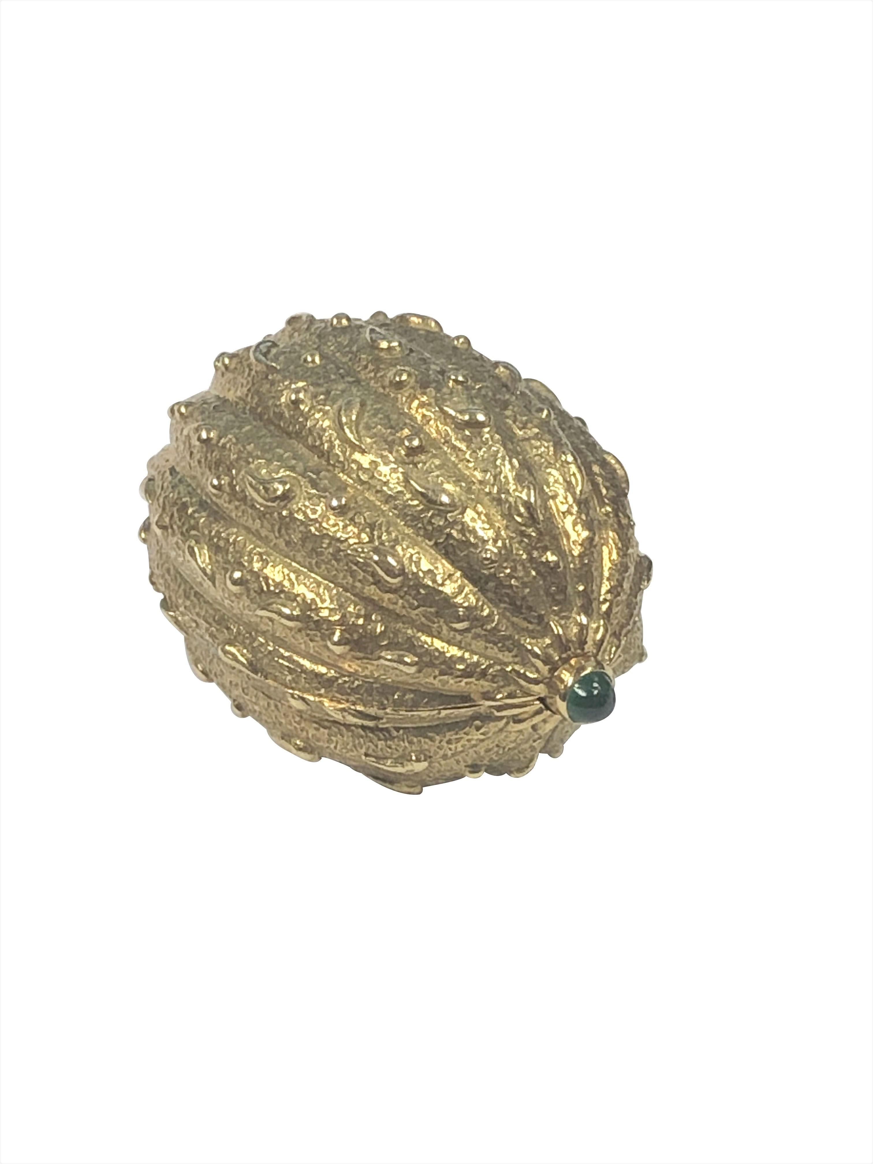 Circa 1970 Jean Schlumberger for Tiffany & Company 18k Yellow Gold Walnut Form Pill Box, measuring 1 3/8 X 7/8 X 5/8 inch and weighing 23.5 Grams, fine detailing and textured with a Cabochon Emerald set at each end. Comes in original Tiffany box. 