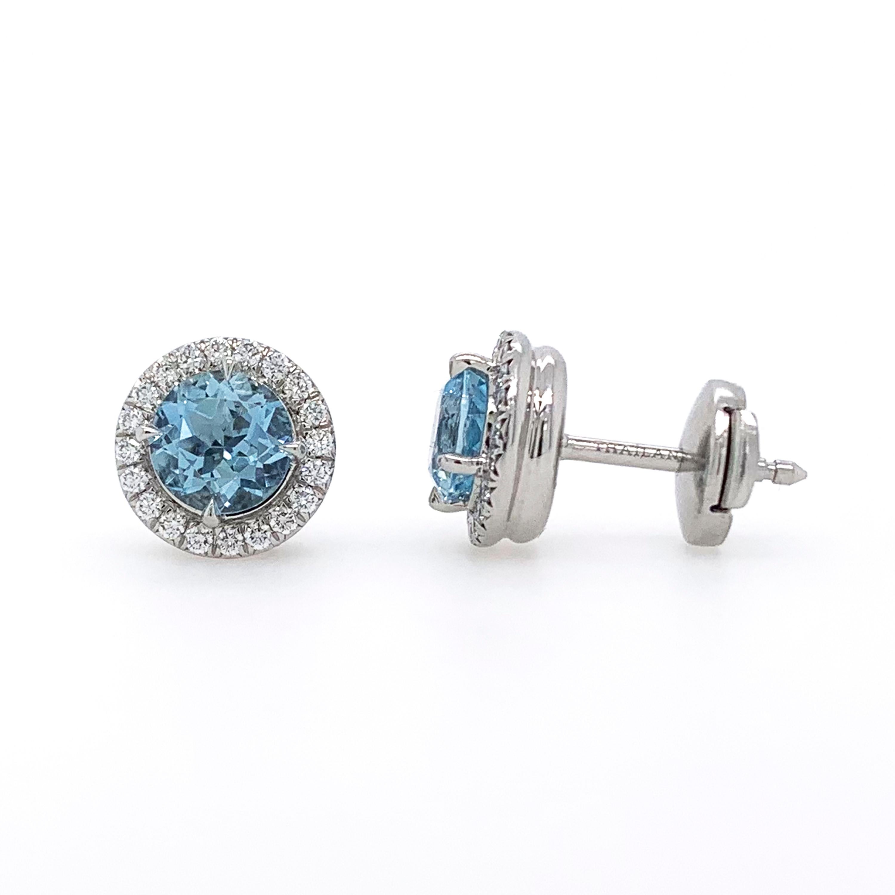 Tiffany & Company Soleste aquamarine and diamond halo style stud earrings in platinum.

This pair of earrings features two 6mm round brilliant cut aquamarines totaling approximately 1.50 carat, as well as approximately 0.20 carats of round brilliant