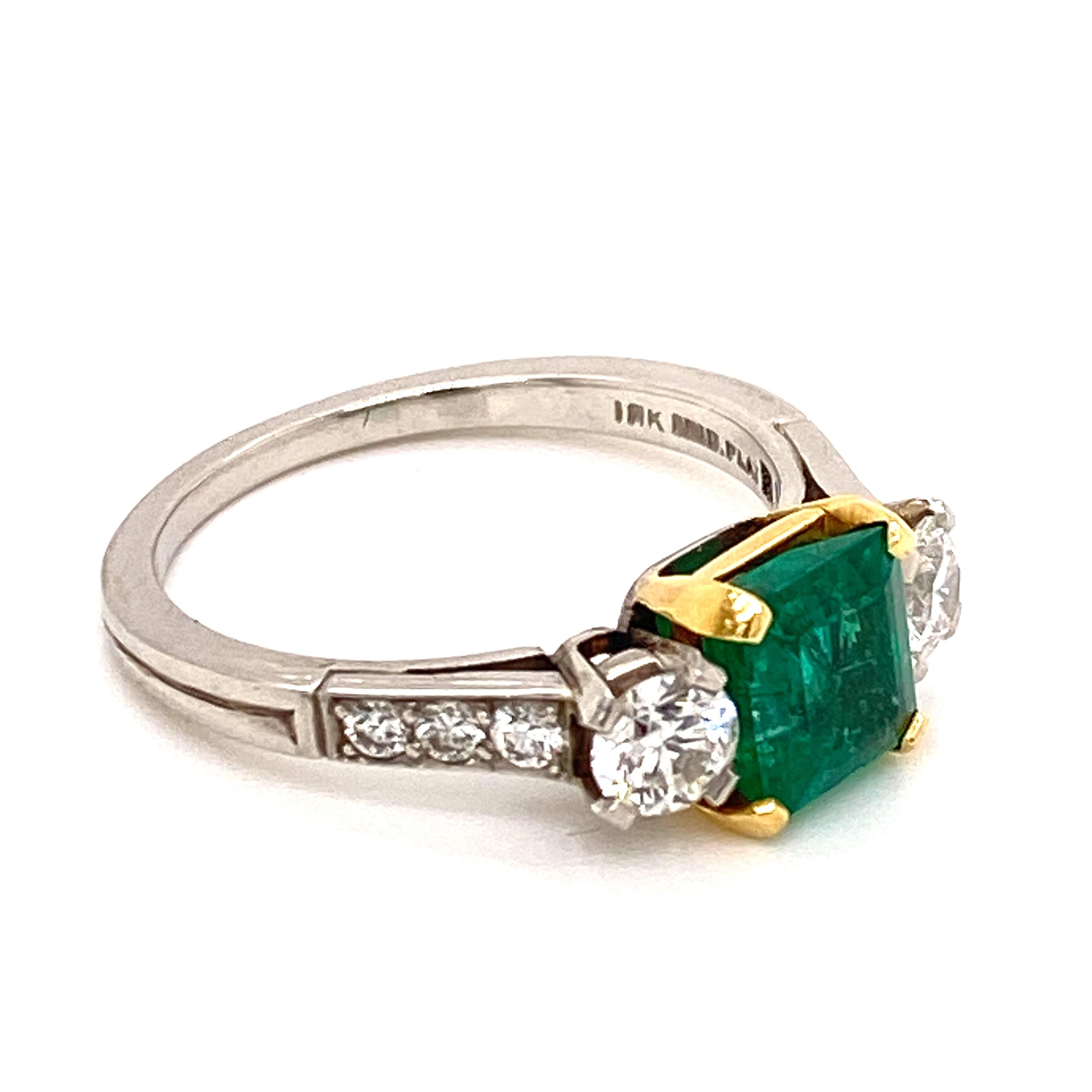 Gorgeous bright green emerald ring crafted by Tiffany & Company. This estate ring features a 1.06 carat Brazilian emerald with an AGL Certificate. The square emerald is flanked by 8 round brilliant cut diamonds (1.00 carat total weight) graded F