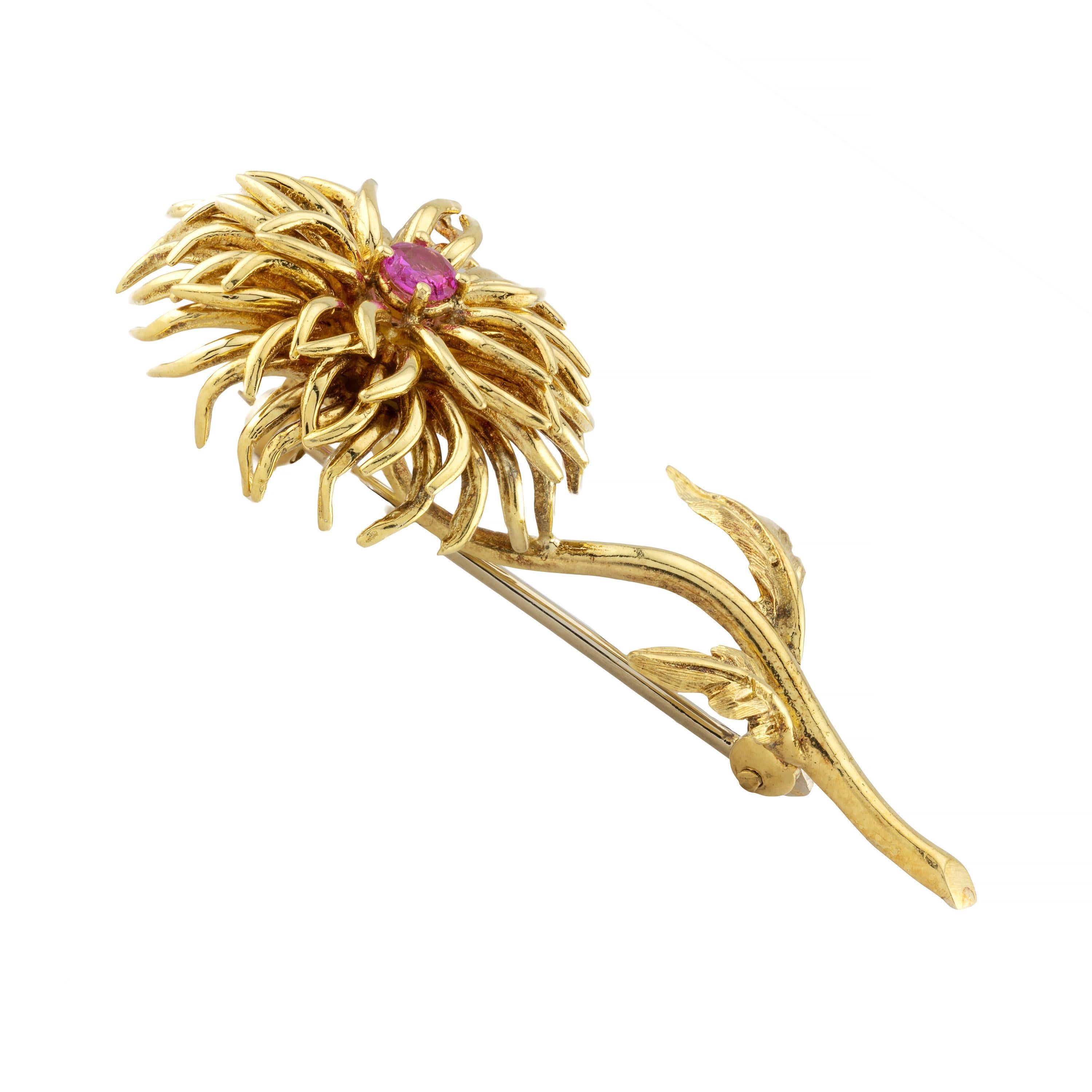 Aston Estate Jewelry Presents:

A vintage circa 1980's Tiffany & Company Dahlia flower brooch. Crafted in brightly polished 18 karat gold, layered elongated petals arranged around a single red ruby.  Accented by hand engraved leaves.  The ruby is of