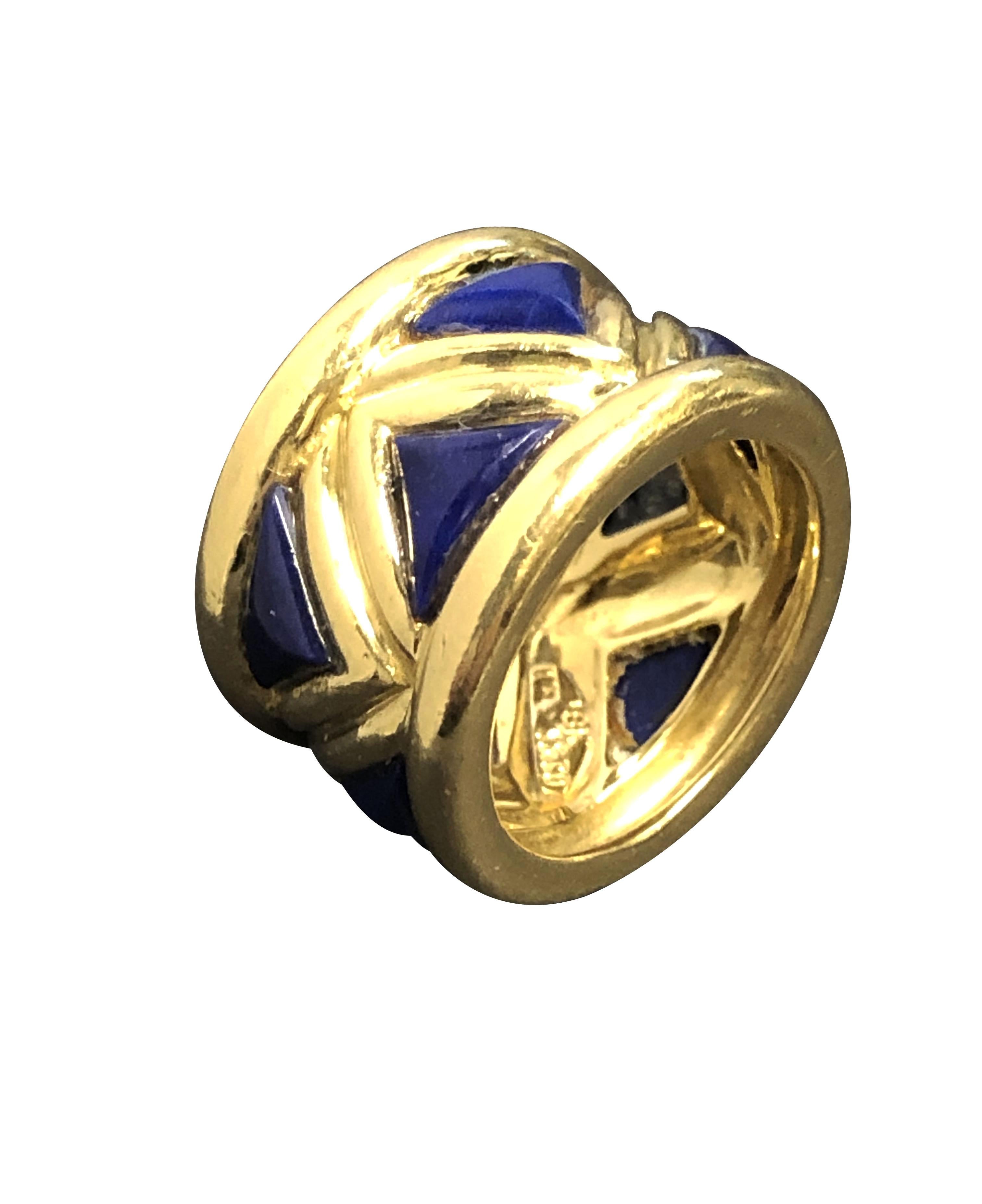 Circa 1980s Tiffany & Company 18K Yellow Gold Band Ring, measuring 1/2 inch wide and having a design of alternating Triangle cut Lapis Lazuli. Finger size 5. 