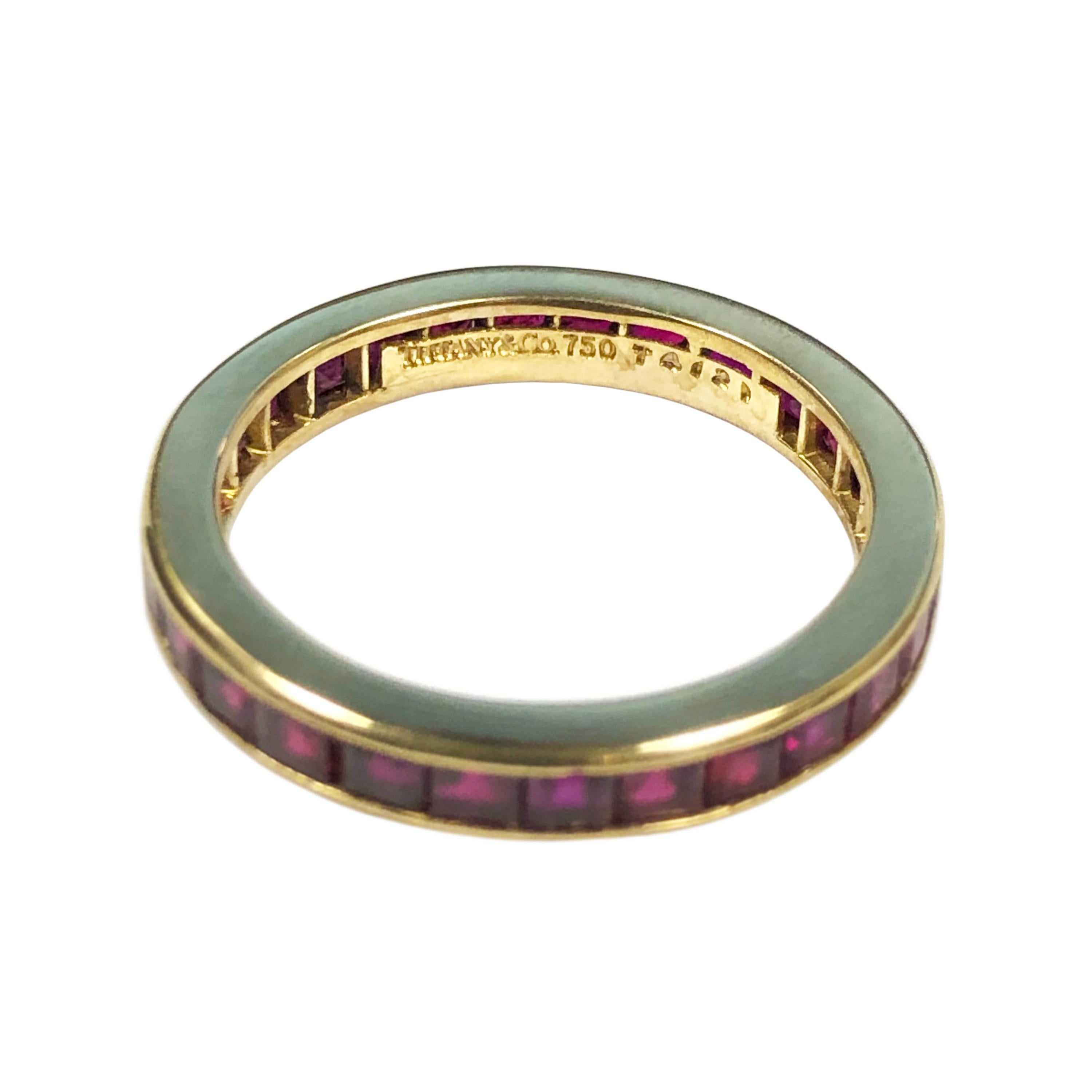 Circa 1990s Tiffany & Company 18K Yellow Gold Eternity Band Ring, set with Square cut Rubies of Fine Burma quality color and totaling approximately 1.50 carats. The ring measures 2.5 M.M. wide and is a finger size 7.  Comes in original Tiffany