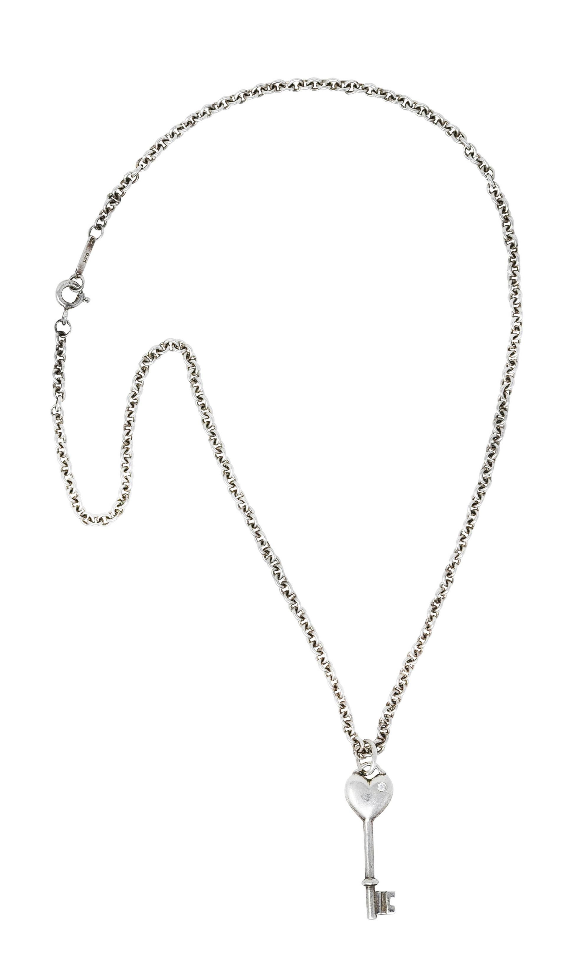 Necklace designed as cable chain suspending skeleton style key 

Featuring puffy heart motif head

Accented by round brilliant cut diamond 

Diamond weighs approximately 0.01 carat - eye clean and bright

Completed by spring clasp

Stamped 925 for