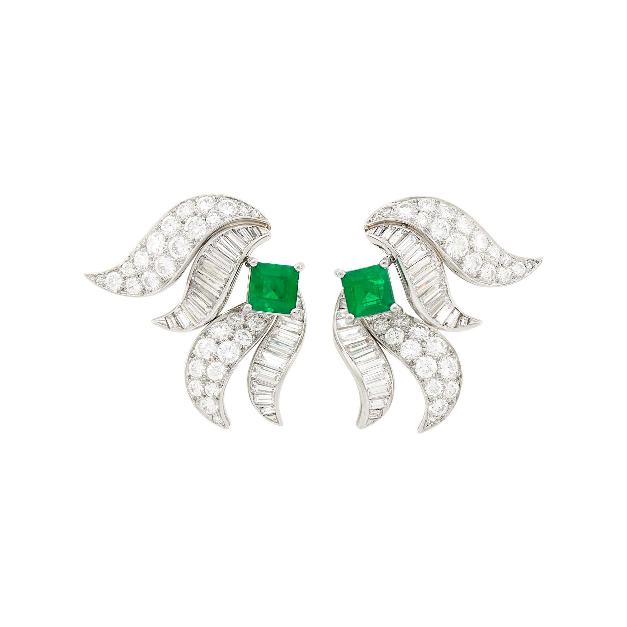 . Pair of Platinum, Emerald   and Diamond Ear-clips 
The flared ribbon earrings centering 2 square-cut emeralds  1.60 carats., set with 50 round and 46 baguette and tapered baguette diamonds ap. 6.20 carats accented by small diamonds all set in