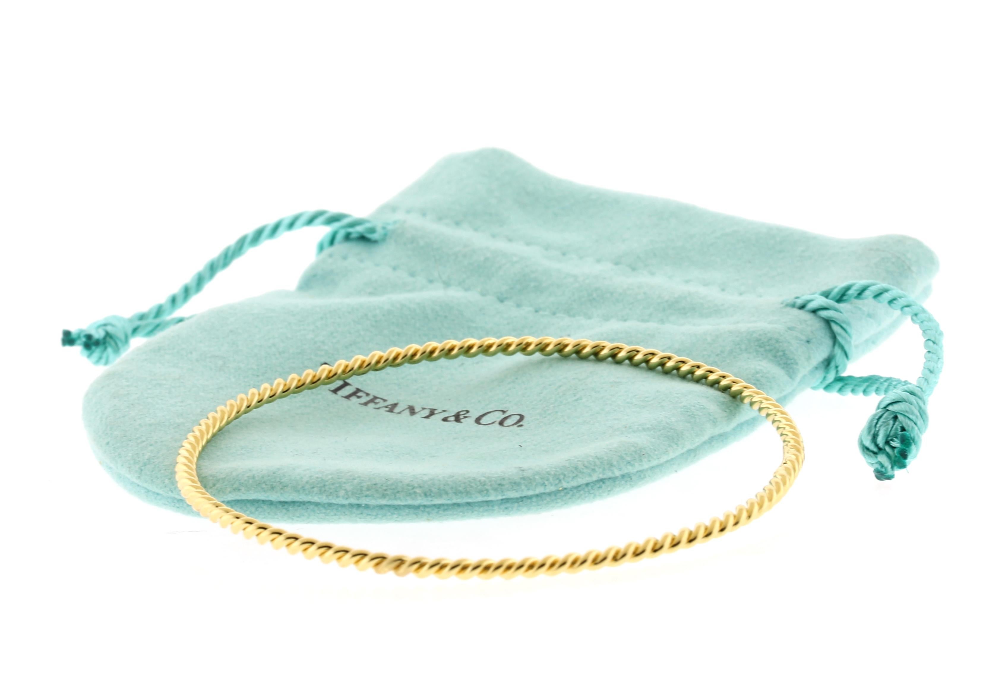 From Tiffany & Co, this twisted bangle is light weight and easy to wear.
• Metal: 18kt Yellow Gold
• Circa: 1990s
• Dimensions: 2 1/2 in Diameter
• Thickness: about 2.2mm
• Weight: 9 grams
• Packaging: Tiffany pouch
• Condition: Excellent Condition