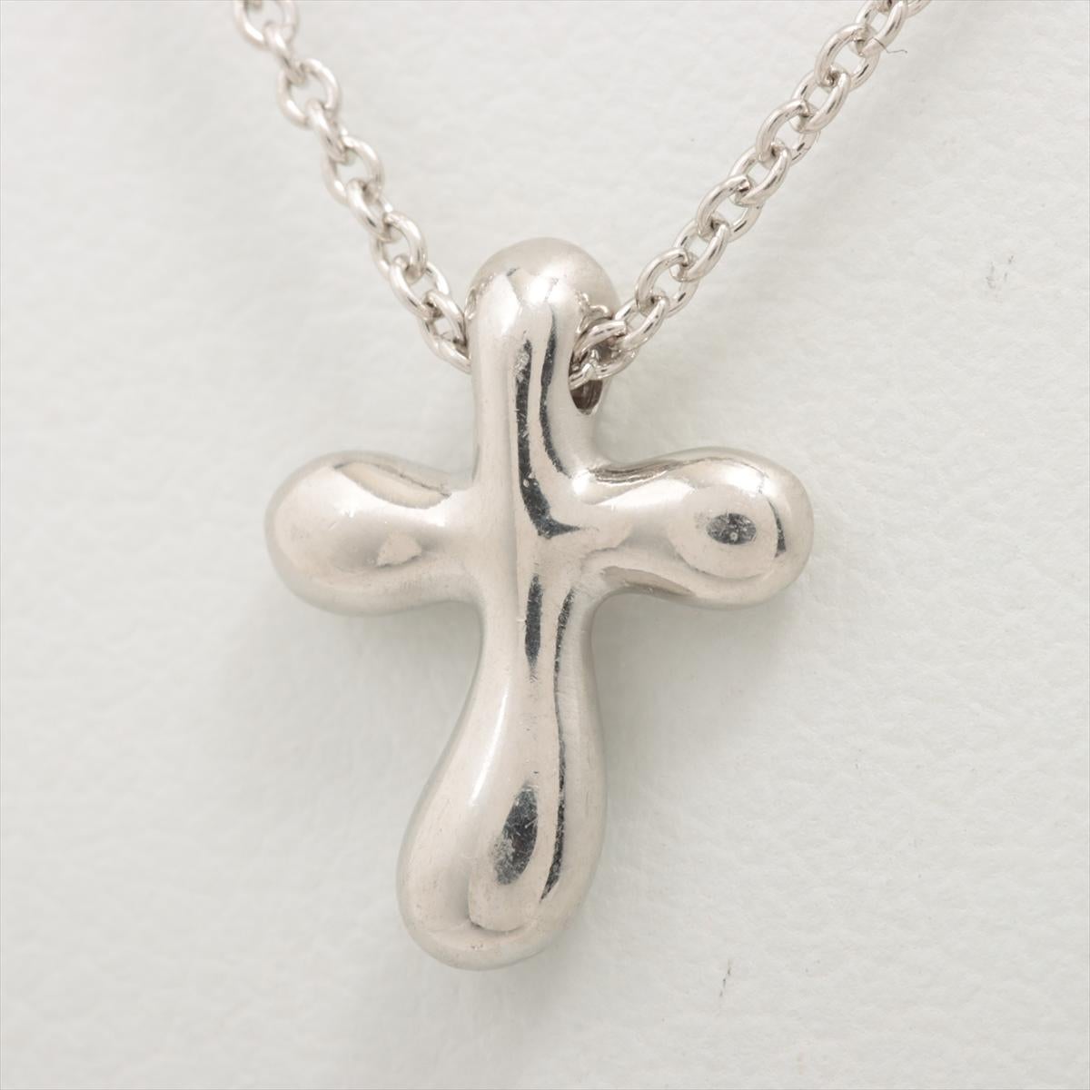 The Tiffany & Co. Small Cross Pendant Necklace in Platinum is a timeless and elegant piece of jewelry that embodies grace and sophistication. Crafted from high-quality platinum, the necklace features a small cross pendant suspended from a delicate
