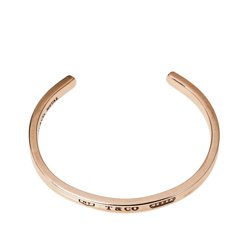 This beautiful Tiffany & Co. cuff bracelet makes an elegant style statement. Inscribed with the year Tiffany was founded, 1837, this rubedo piece is defined by smooth and polished contours and a narrow silhouette. You will treasure this charming