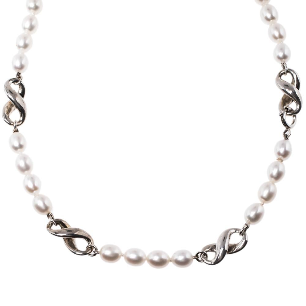 This Tiffany & Co. necklace evokes beauty in a delicate way. Made from silver, the chain holds Figure 8 details and cultured pearls. The necklace can be fastened to your neck with the help of the spring-ring clasp.

Includes:Original Dustbag,