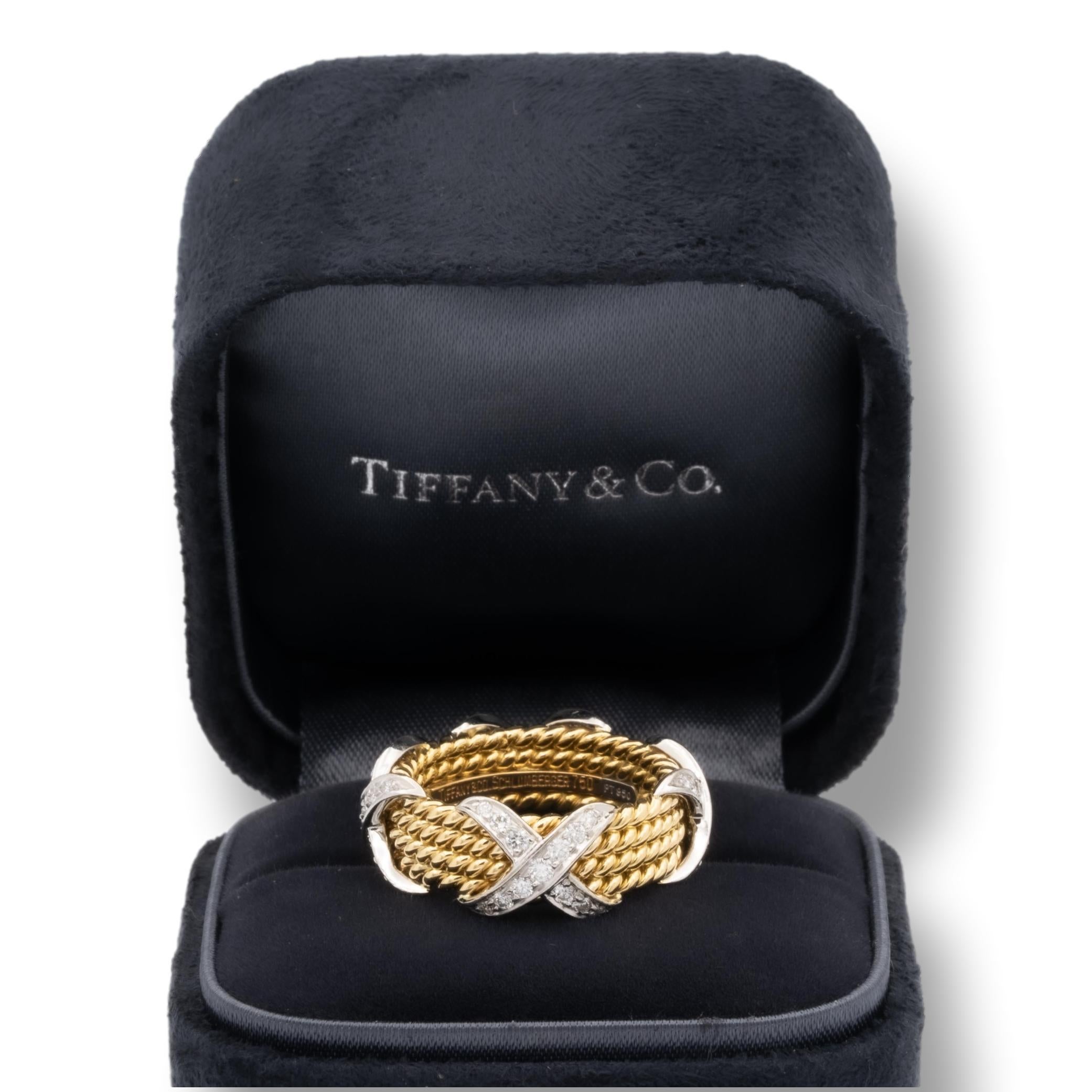 Tiffany & Co. Schlumberger X 4 row rope wide ring finely crafted in 18 karat yellow gold and platinum. The 4 X's are set with 52 round brilliant cut diamonds inside a channel weighing 0.54 carats total weight. 


Stamp: Tiffany & Co. Schlumberger
