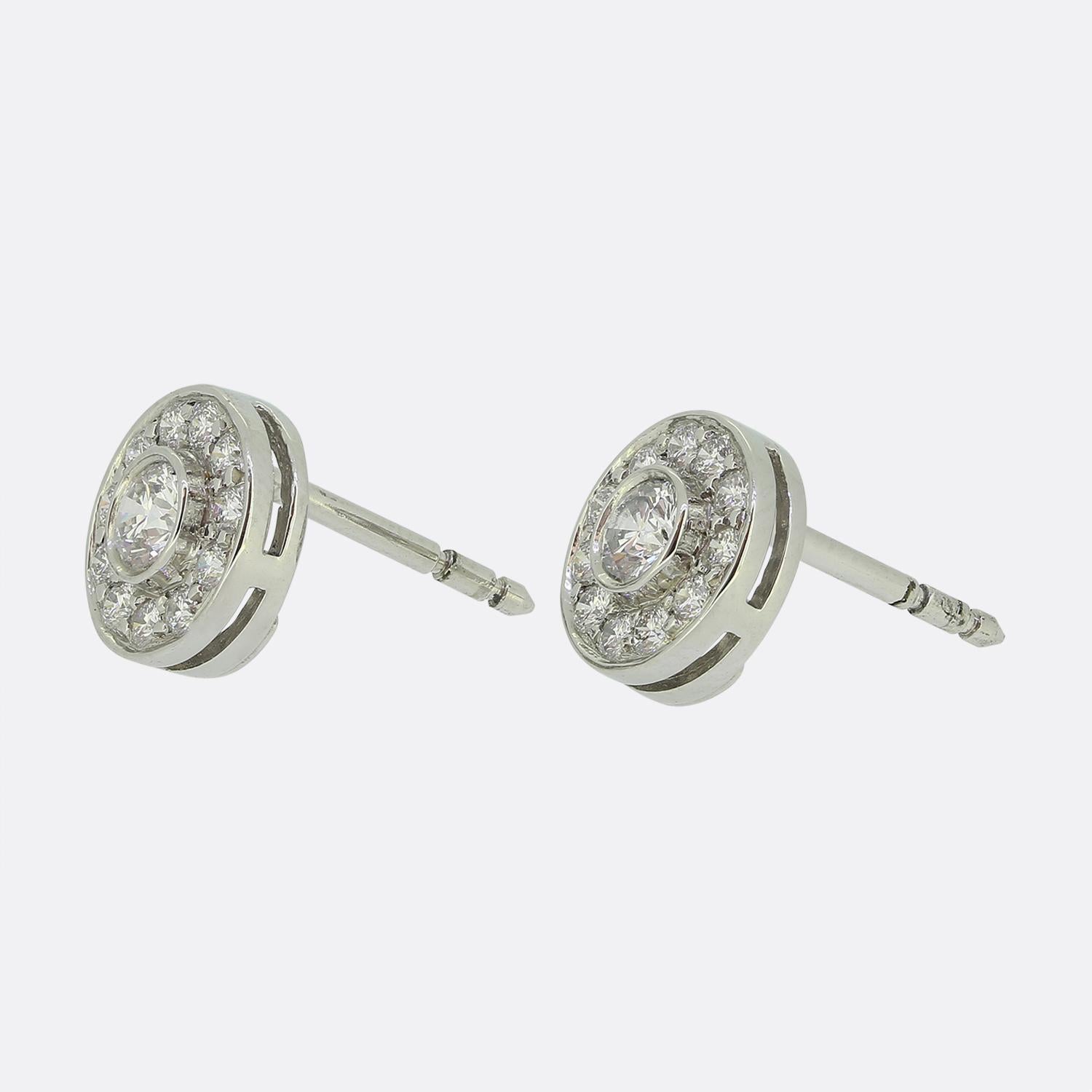Here we have a wonderful pair of diamond earrings from the luxury jewellery designer Tiffany & Co. Each earring features a central diamond surrounded by a halo of 11 smaller diamonds. The earrings form part of the circlet collection and are perfect