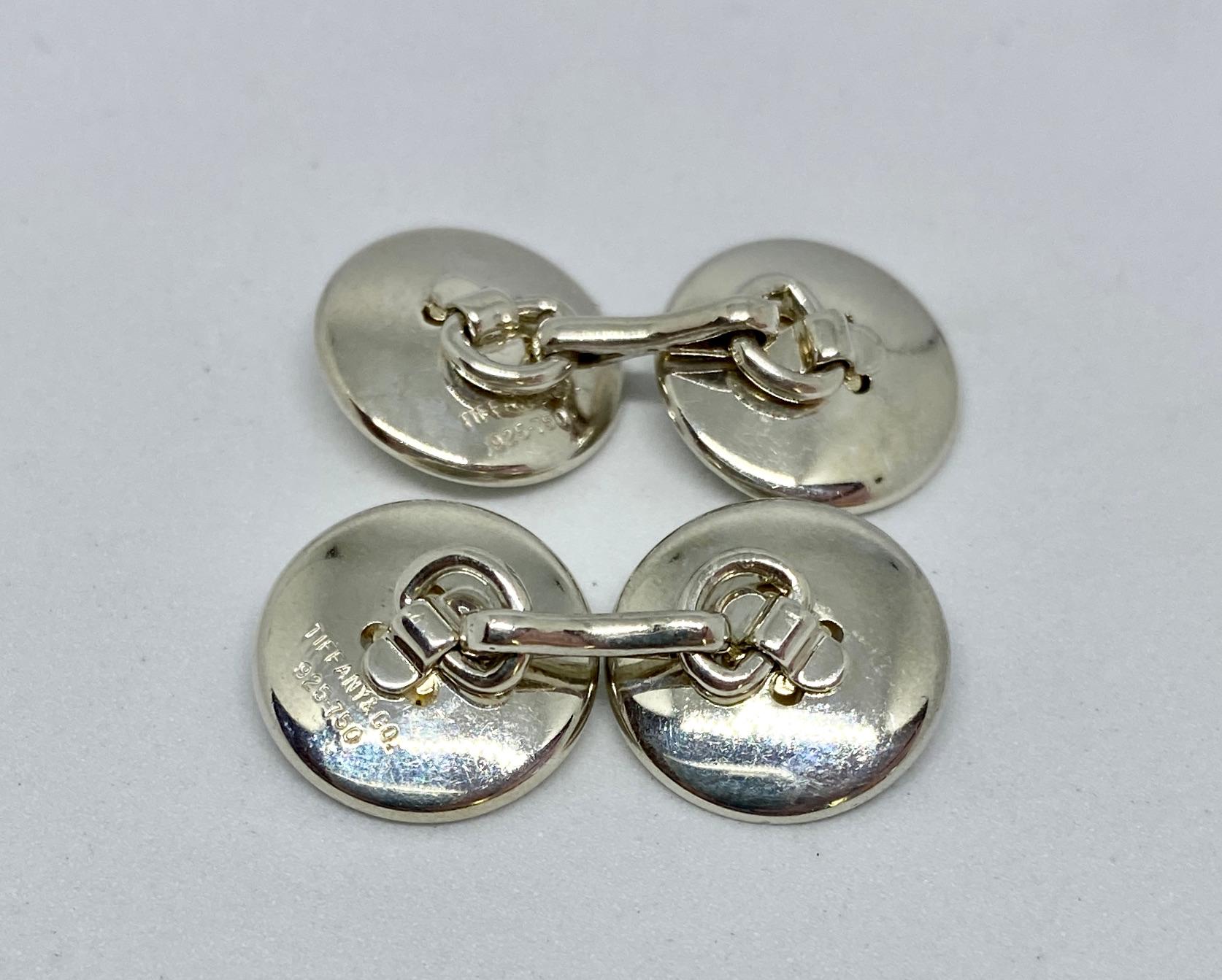 A classic and popular Tiffany design, yet hard to find in this desirable double-sided version.

The four sterling silver buttons each feature 18K yellow gold 