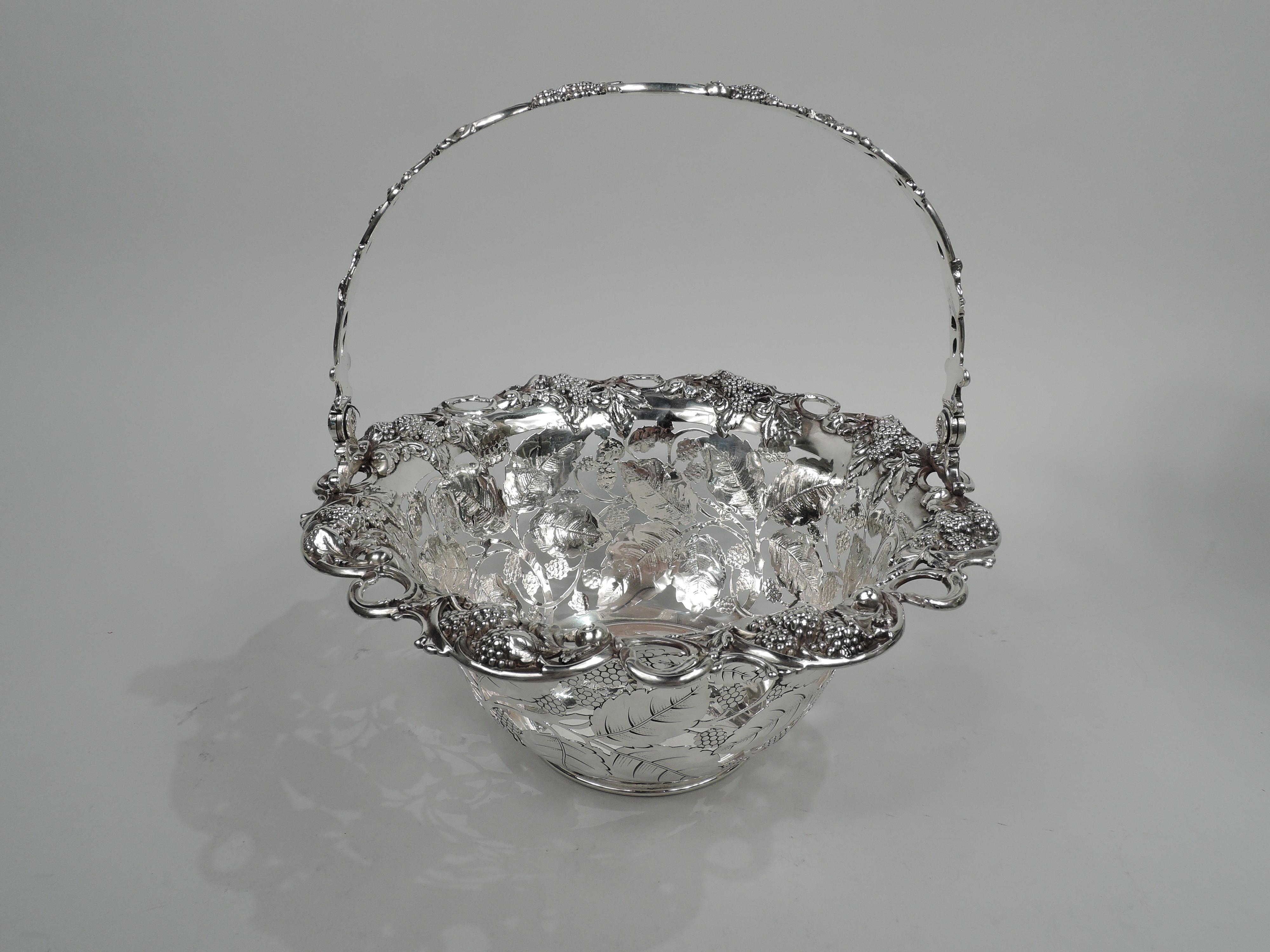 Edwardian sterling silver basket with blackberry motif. Made by Tiffany & Co. in New York, ca 1910. Plain and solid well. Curved and open sides comprising fruiting blackberry branches heightened with engraving. Open and scrolled rim with more