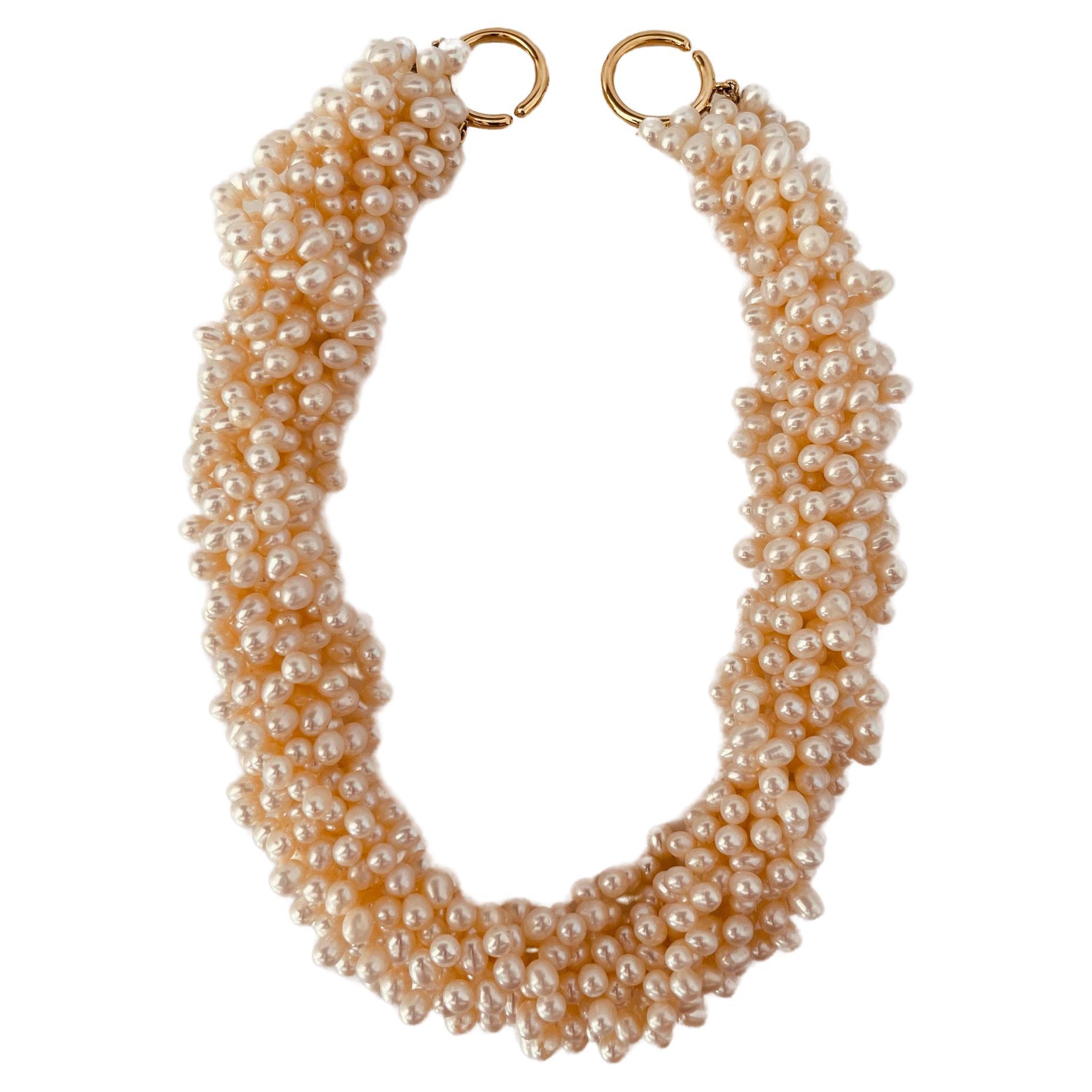 Eight-strand freshwater pearl necklace to 18ct gold interlocking hoops. 46cm length. Weight: 203.2 grams. Signed Tiffany 750 and Paloma Picasso. Black leather envelope maker's case. Circa 1990s. Price: 2,970£. Item is in very good condition without