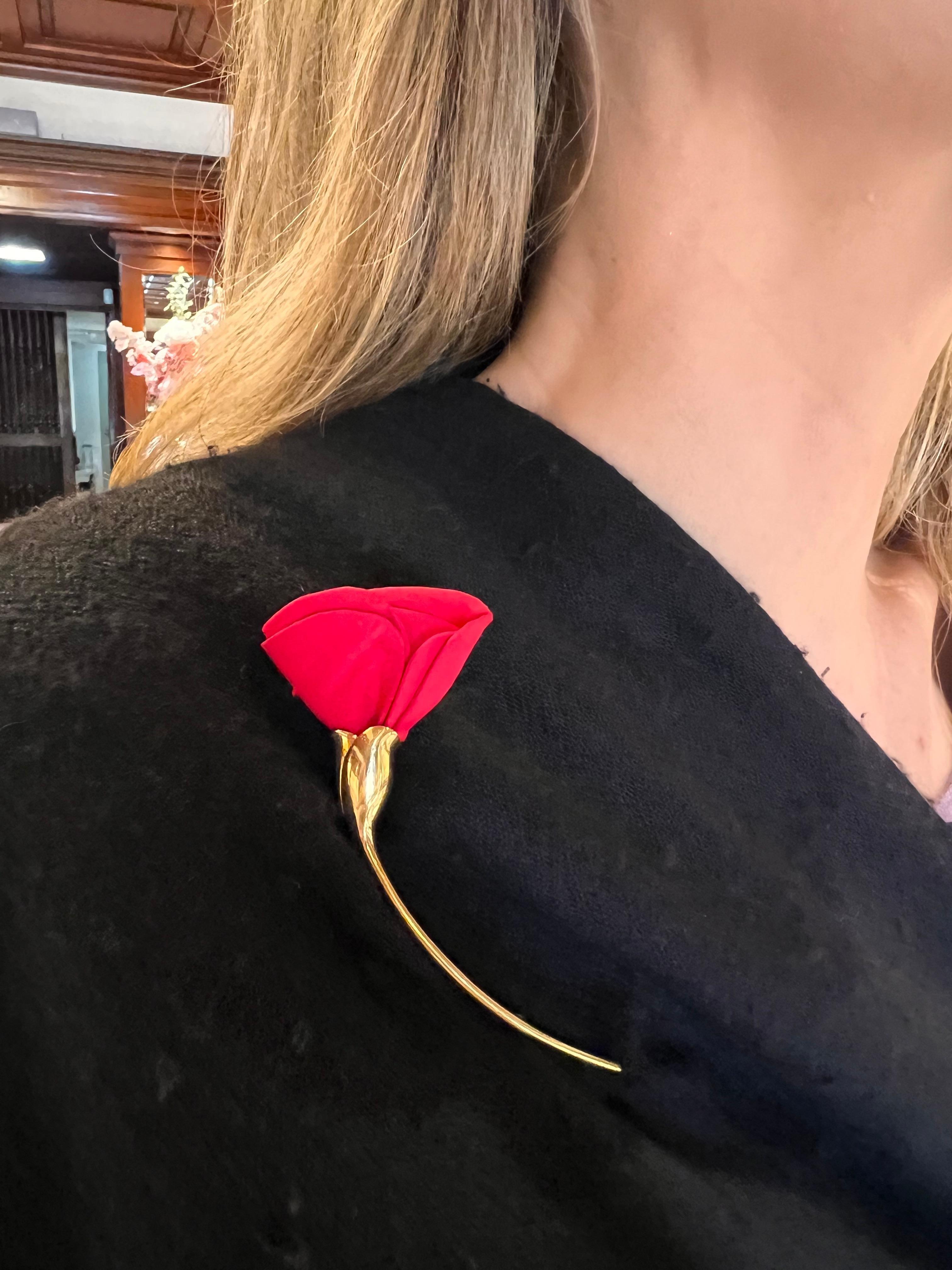 Beautiful 'Amapola' poppy flower brooch by renowned designer 'Elsa Peretti' for Tiffany & Co.  The petals are created out of red silk perched on a polished 18k yellow gold stem.  The pin closure mechanism follows the contour of the elongated stem. 