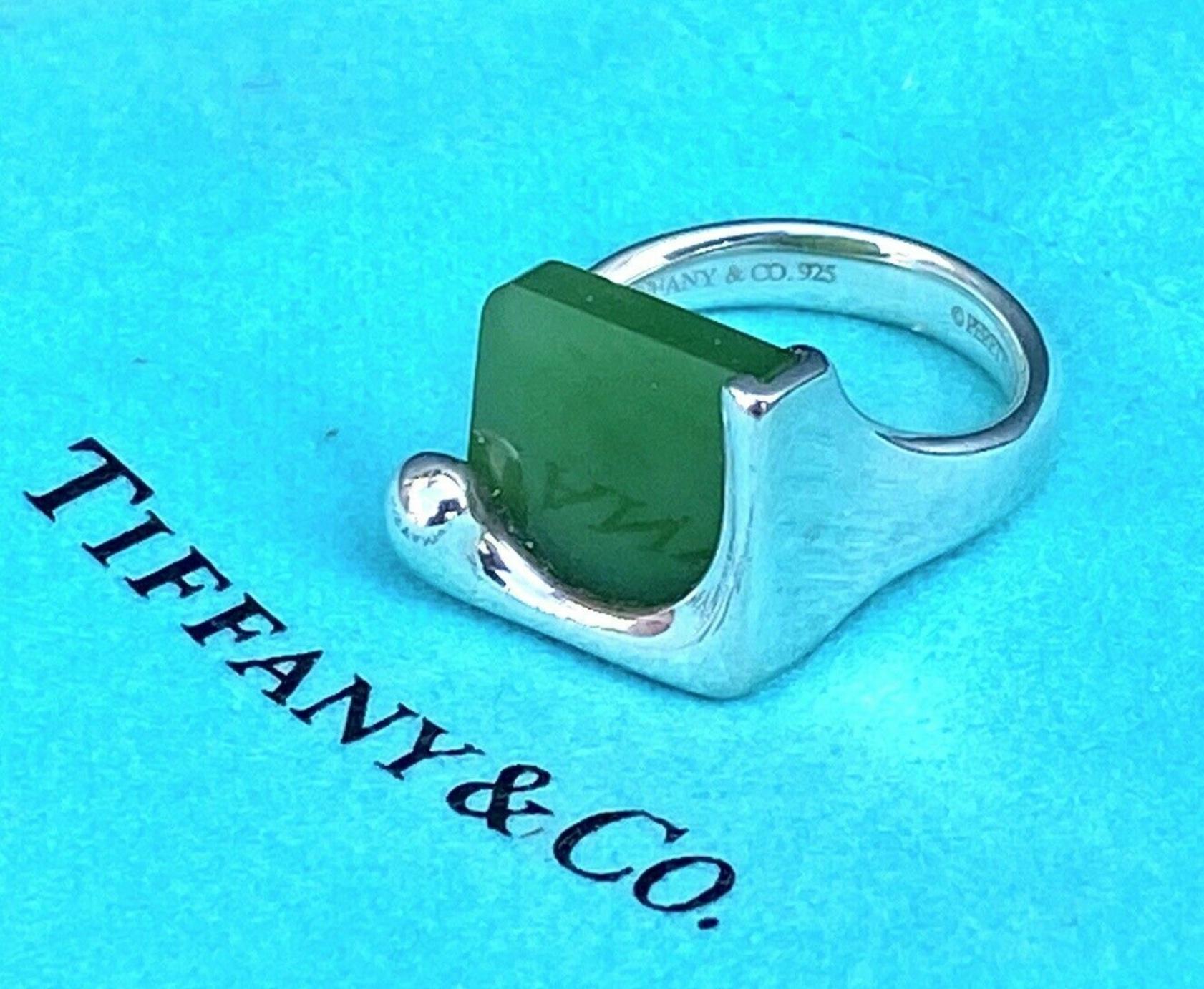 Sterling silver and jade.  Graceful yet modern in design, the free-flowing curves and jade are endlessly elegant.
