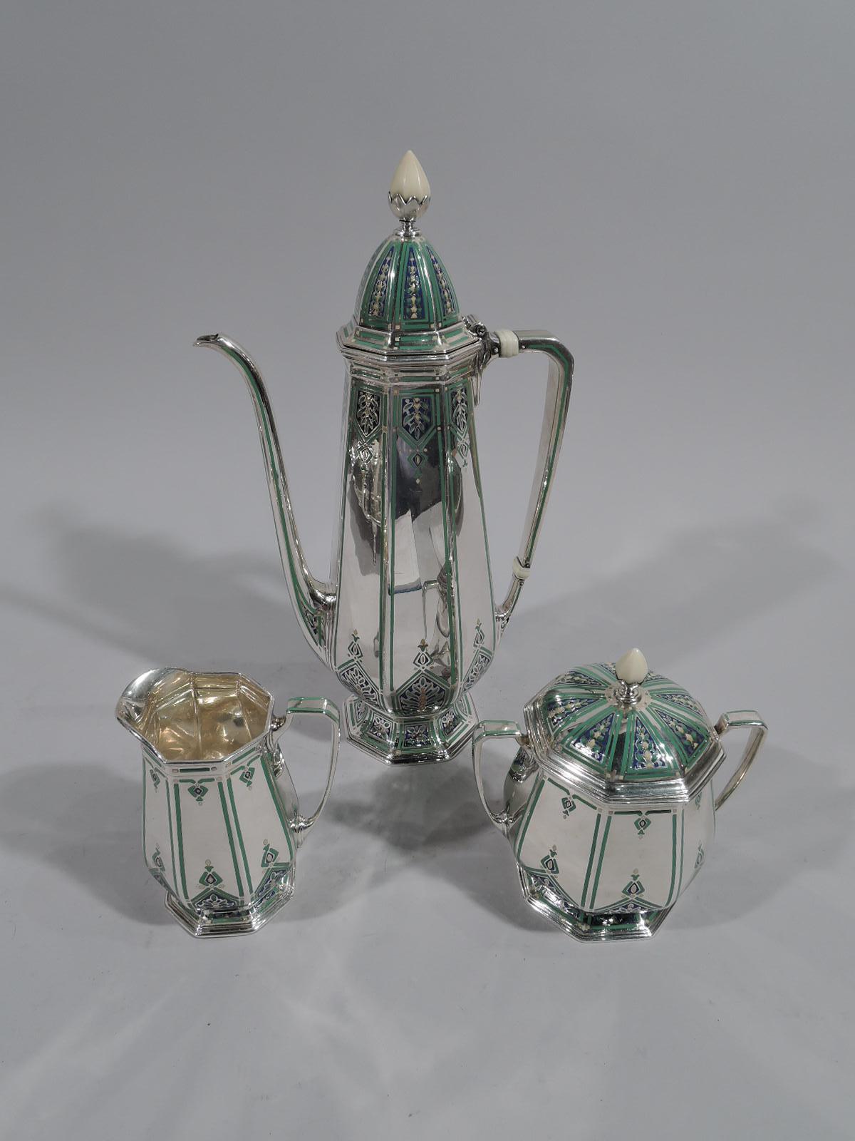 Fabulous Art Deco sterling silver coffee set on tray with enameled ornament. Made by Tiffany & Co. in New York, circa 1926. This set comprises coffeepot, creamer, sugar, and tray.

Coffeepot, creamer, and sugar have faceted baluster body, faceted,