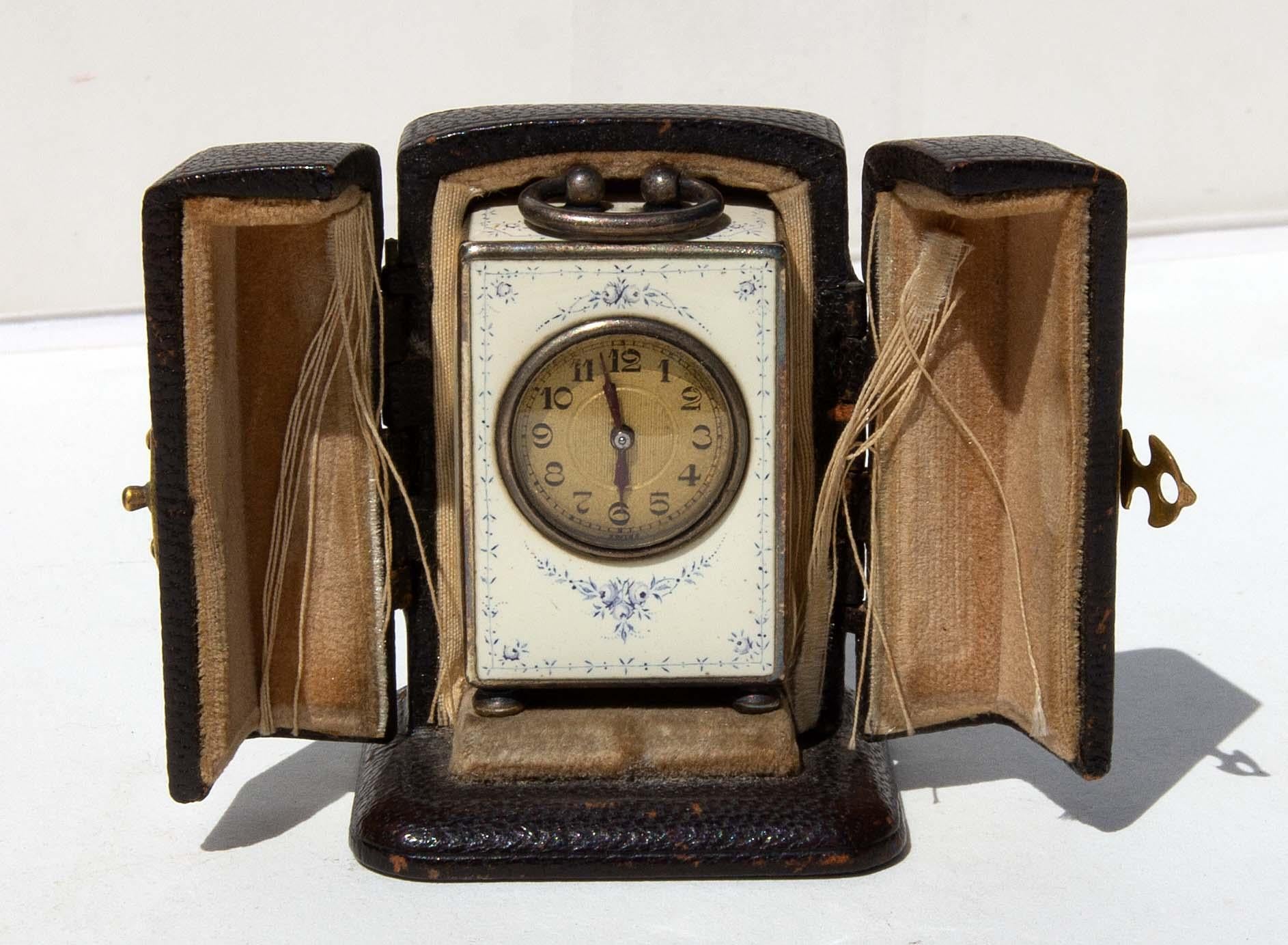 Tiffany & Co. sterling silver blue and white 15 jewel enameled travel clock. Includes original fitted leather bound presentation case. Made by Swiss watch maker Concord. Hallmarked, circa 1920. Monogrammed on back.