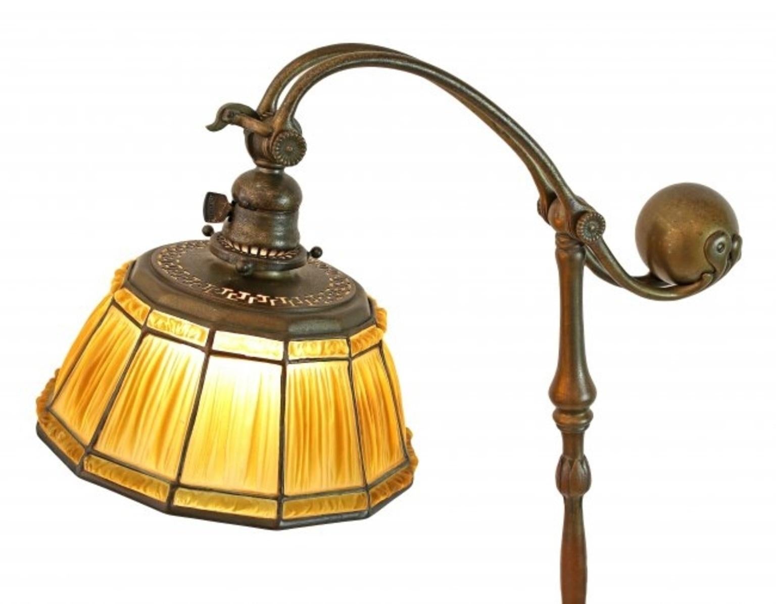 A Tiffany favrile glass and bronze 'Linenfold' counter balance floor lamp,
1899-1920.
Timeless, moderately rare and very desirable, the vivid amber 'linenfold' shade impressed with Tiffany Studios 1936,
the base impressed TIFFANY/STUDIOS/NEW YORK