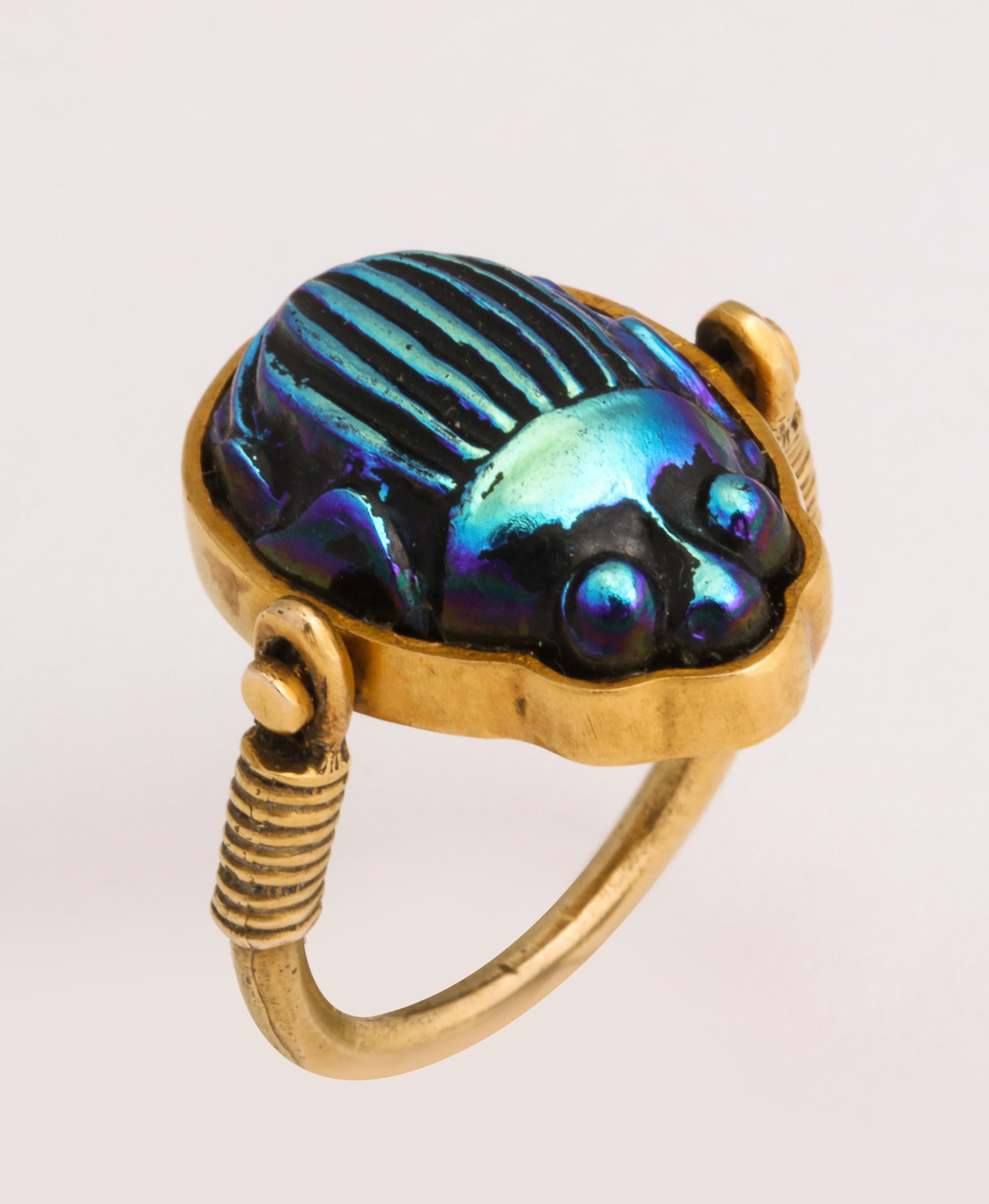 Scarab ring mounted in handmade Mounting.  Hand set  Iridescent Scarab which pivots and one can see Hieroglyphs on the reverse.  Set in 14kt Yellow Gold.  Scarab ca 1920-30 - after the Discovery of Tutankhamen's Tomb.  Mounting ca 1970/80 .  Size 5