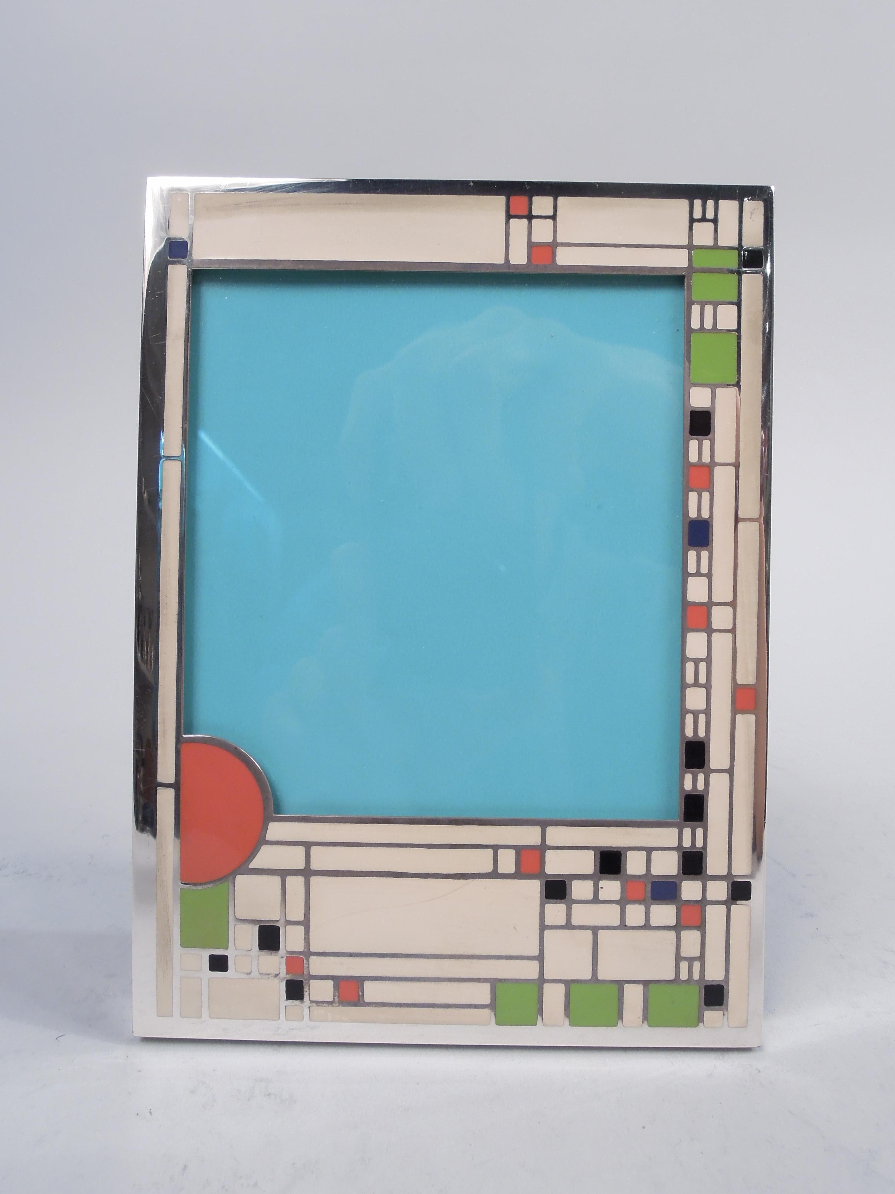 Frank Lloyd Wright-inspired sterling silver and enamel picture frame, ca 1980. Retailed by Tiffany & Co. in New York. Rectangular surround based on stained-glass window design with mostly white as well as some colored blocks in irregular rectilinear