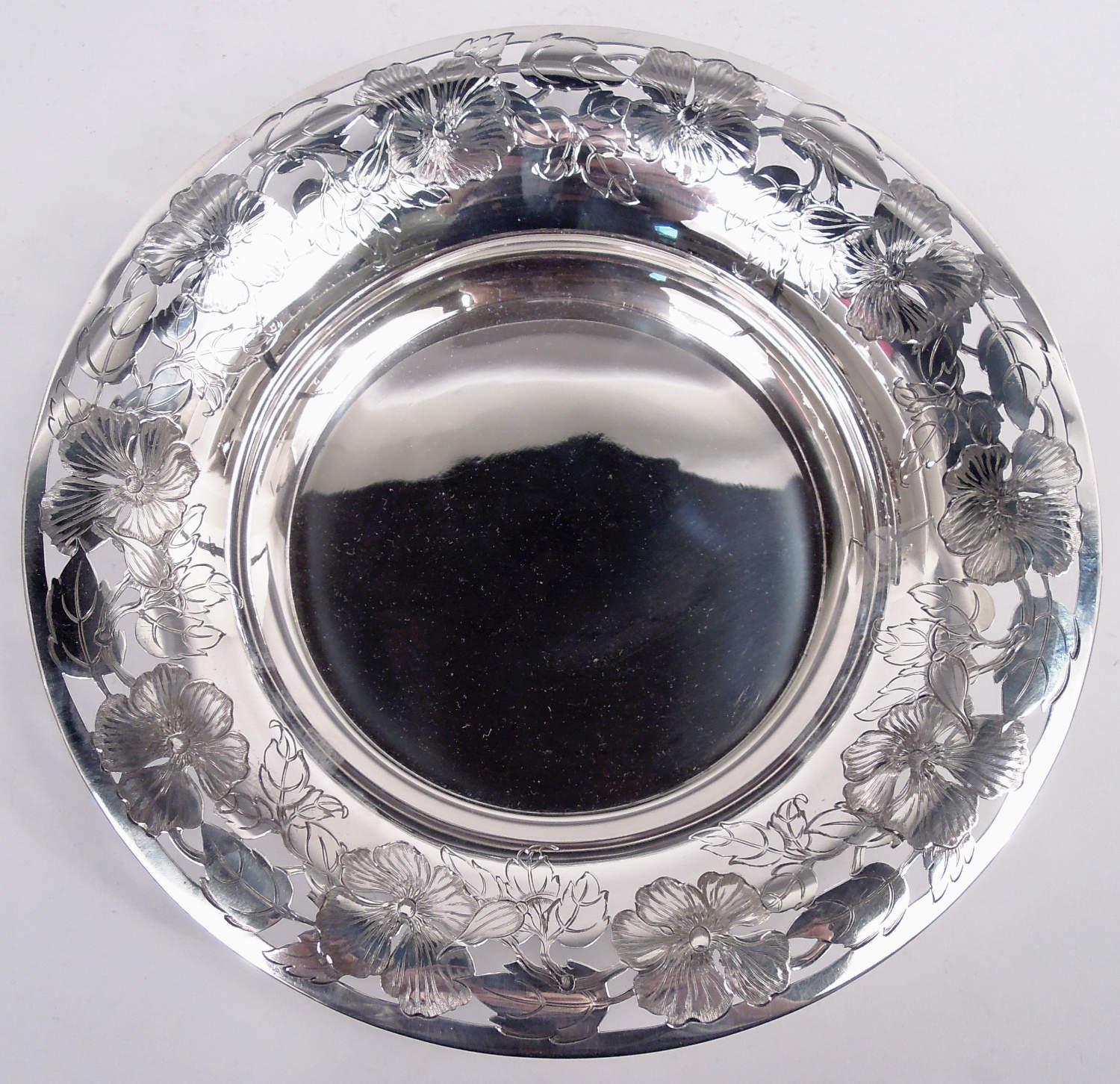 Fresh and pretty Art Nouveau sterling silver bowl. Made by Tiffany & Co. in New York, ca 1911. Round and solid well. Open rim with chased flowering and leafing branch. Fully marked including maker's stamp, pattern no. 18058A (first produced in