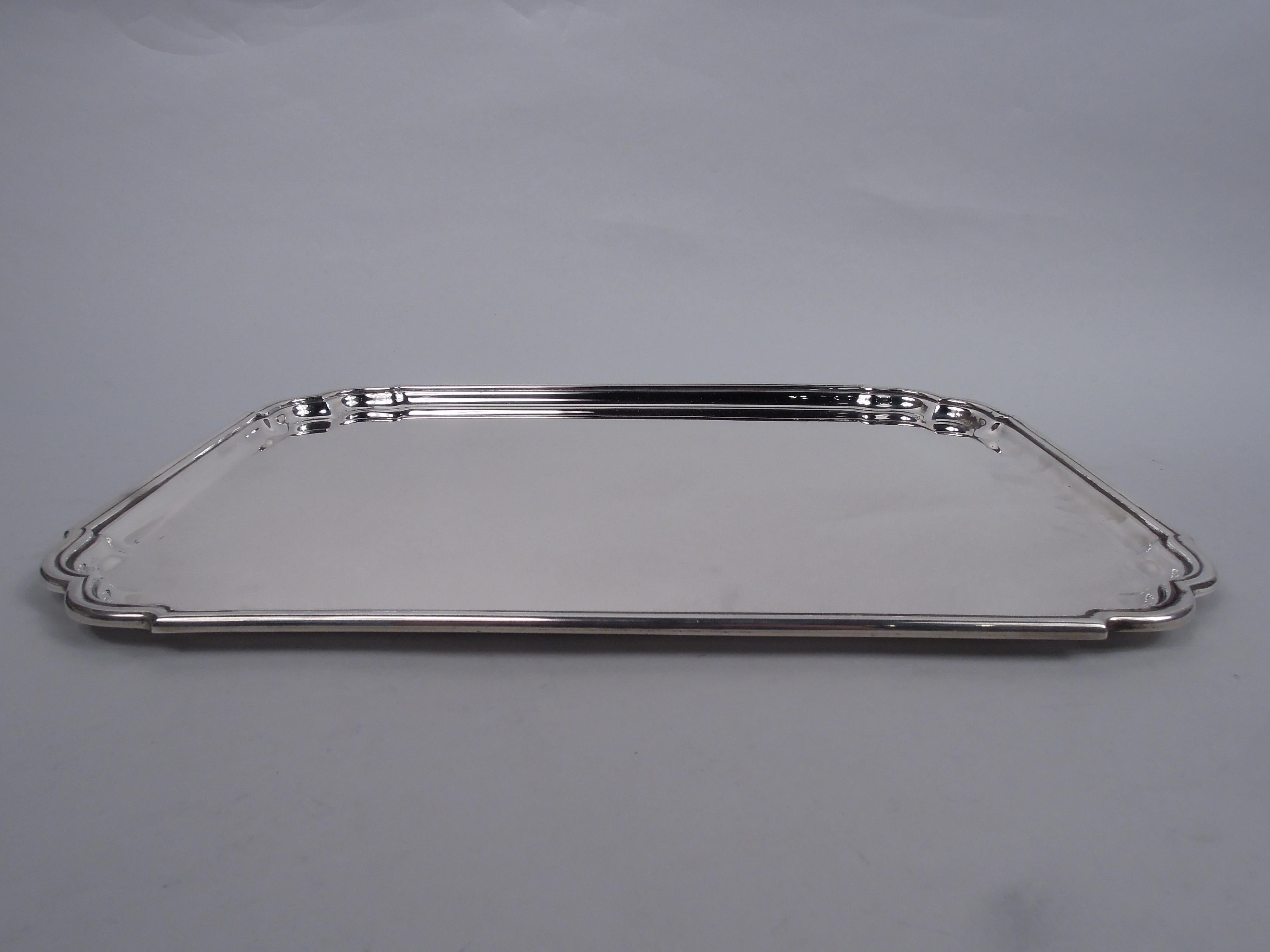 Georgian-inspired sterling silver tray. Made by Tiffany & Co. in New York. Rectangular with molded rim and double c-scroll corners. A great midcentury take on 18th-century design. Fully marked including maker’s stamp and postwar pattern no. 23967.
