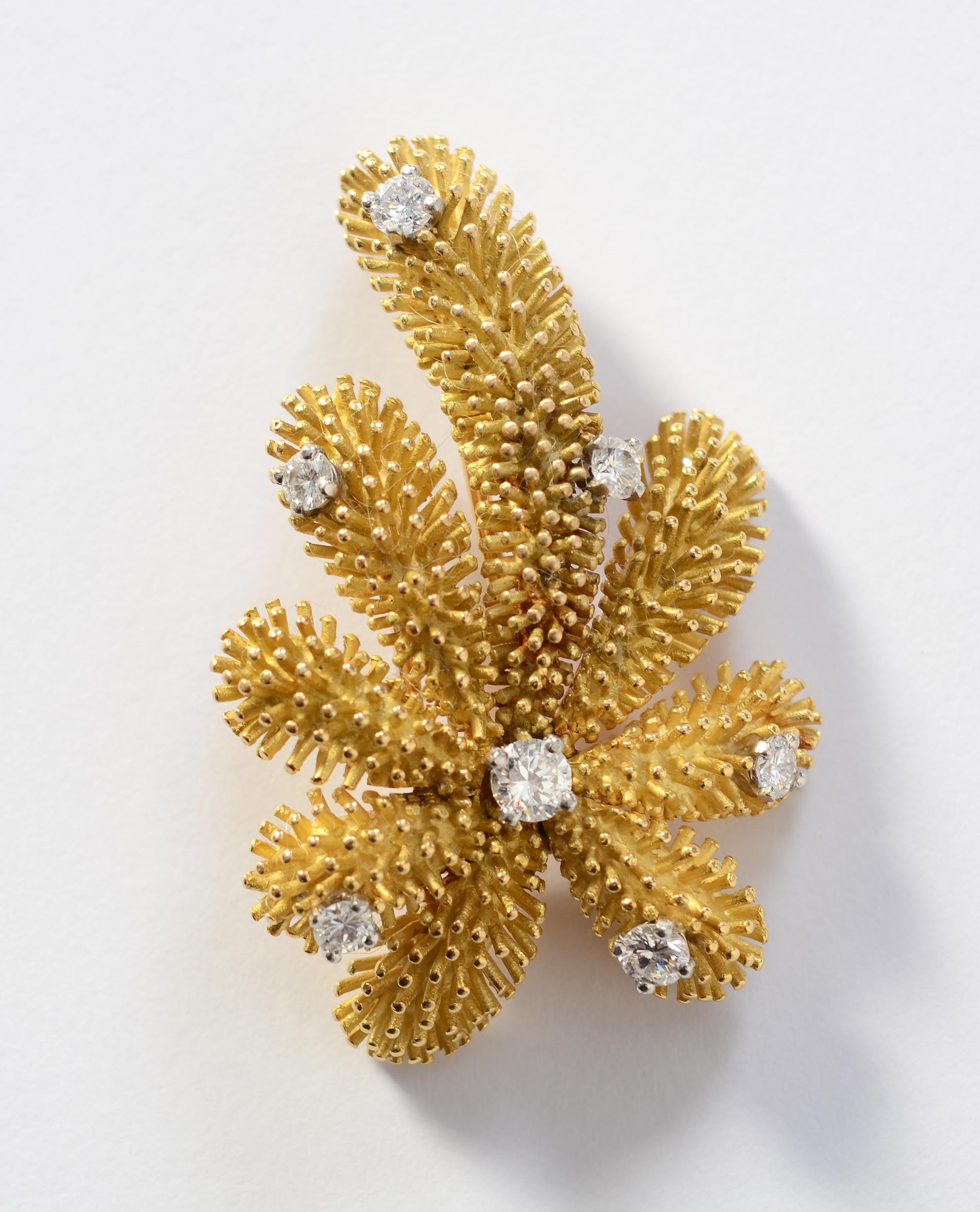 Missing a warm weather vacation this year? This Palm Tree brooch by Tiffany will bring back fond memories.
The brooch has a detailed sea urchin texture.  Seven prong set diamonds weigh a total of approximately 1 carat. The stones are H-I color; SI 1