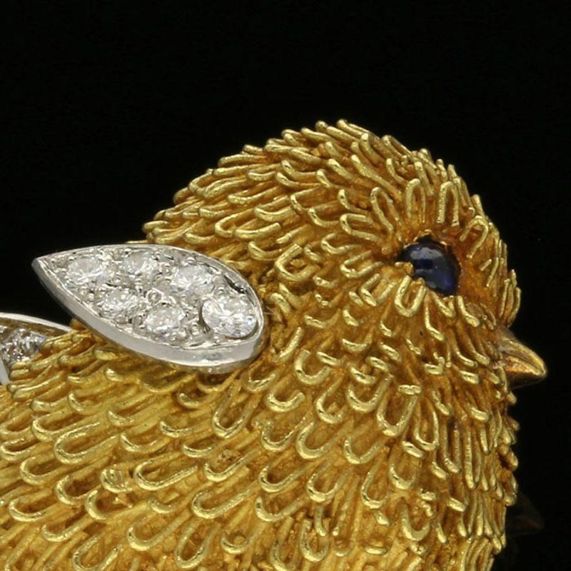 A delightful gold bird brooch by Tiffany & Co. c. 1950s, modelled as a little chick in 18ct yellow gold with fine gold wire loops depicting the fluffy feathers, the wings in platinum set with round brilliant cut diamonds and the eyes with round