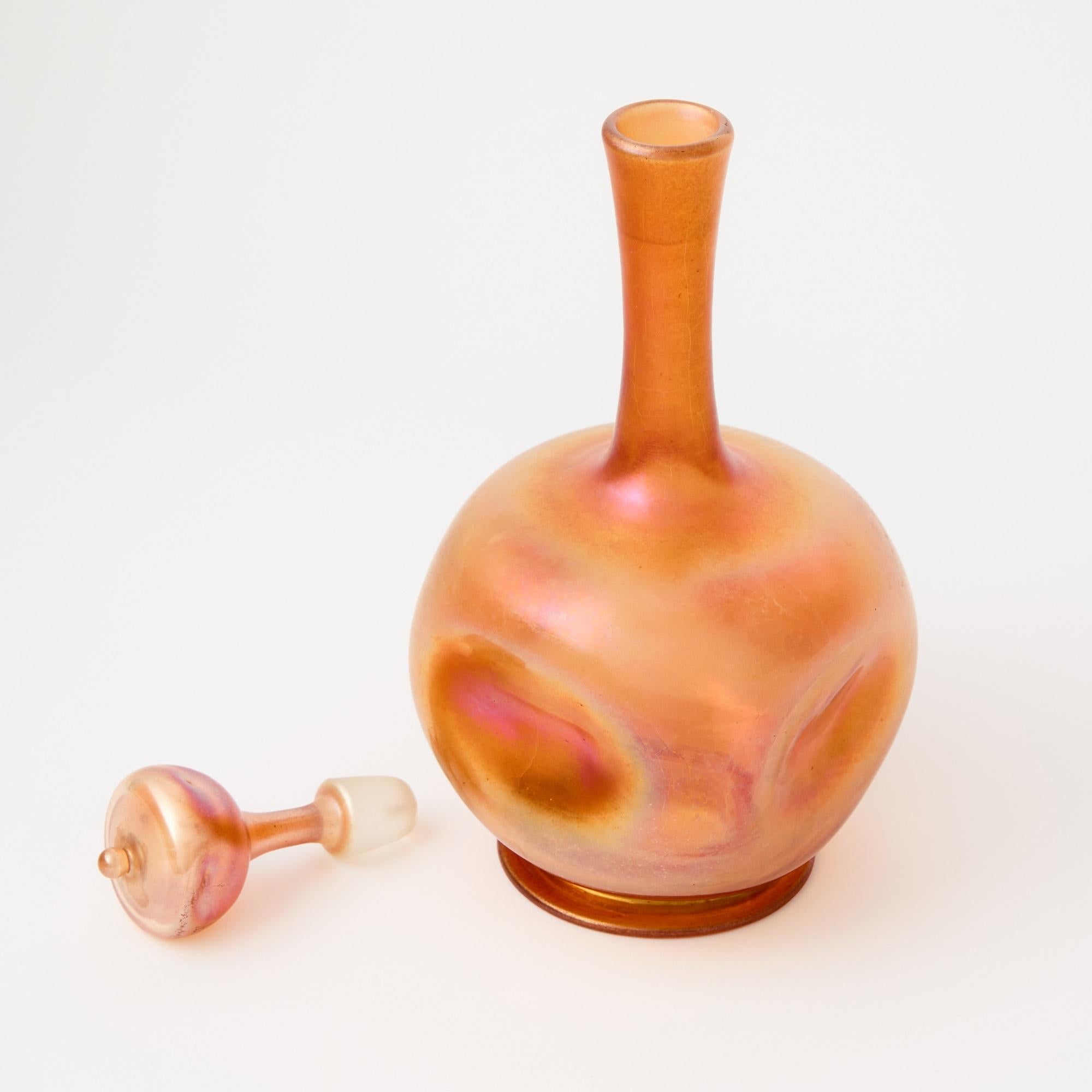 A remarkable early 20th century cordial service by Louis Comfort Tiffany, circa 1902, exemplifying the artist’s mastery of Favrile blown glass. The set comprises a decanter with stopper and six matching cordial glasses, each crafted in translucent