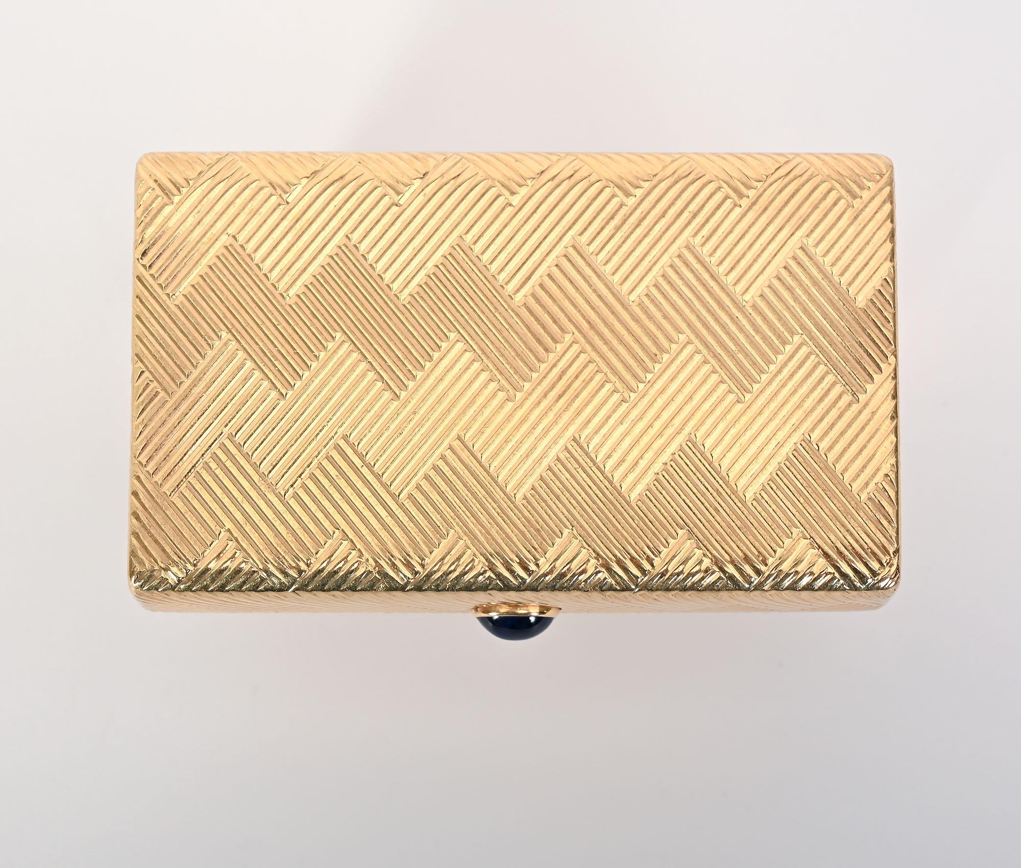 Elegant 14 karat gold minaudiere  by Cartier from the 1940's. This Retro piece has a double zig zag design on all surfaces. The clasp is a cabochon sapphire. The box measures 2 7/8 inches wide; 1 5/8 inches deep and 5/8 inch tall. It is in excellent