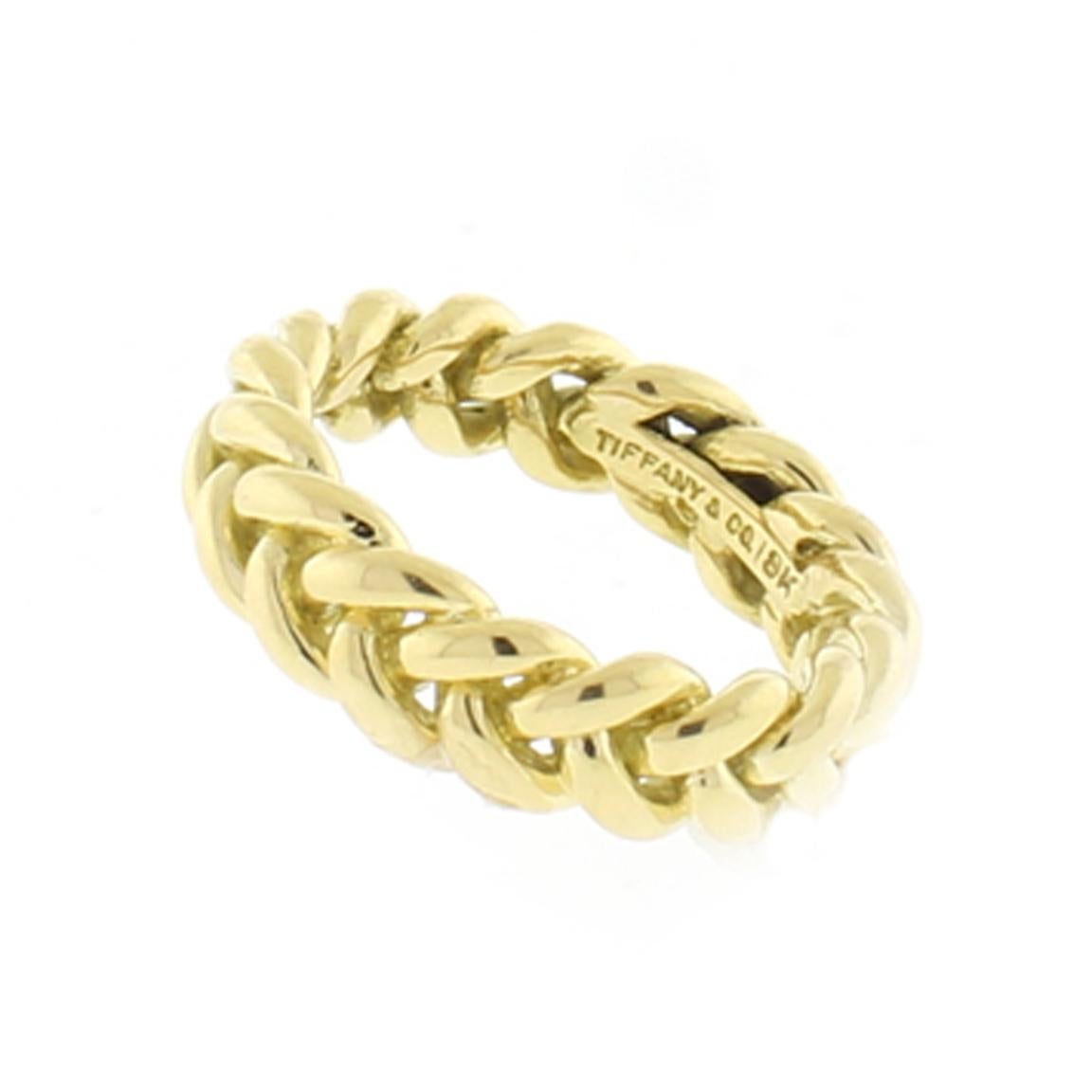 From Tiffany, an 18 karat gold woven band ring.
• Designer Tiffany & Co.
• Metal: 18 karat gold
• Weight: 11 grams
• Width: 6mm
• Circa: 21st Century
• Size: 7 3/4 cannot be resized
• Packaging:  Tiffany Pouch
• Condition: Excellent
