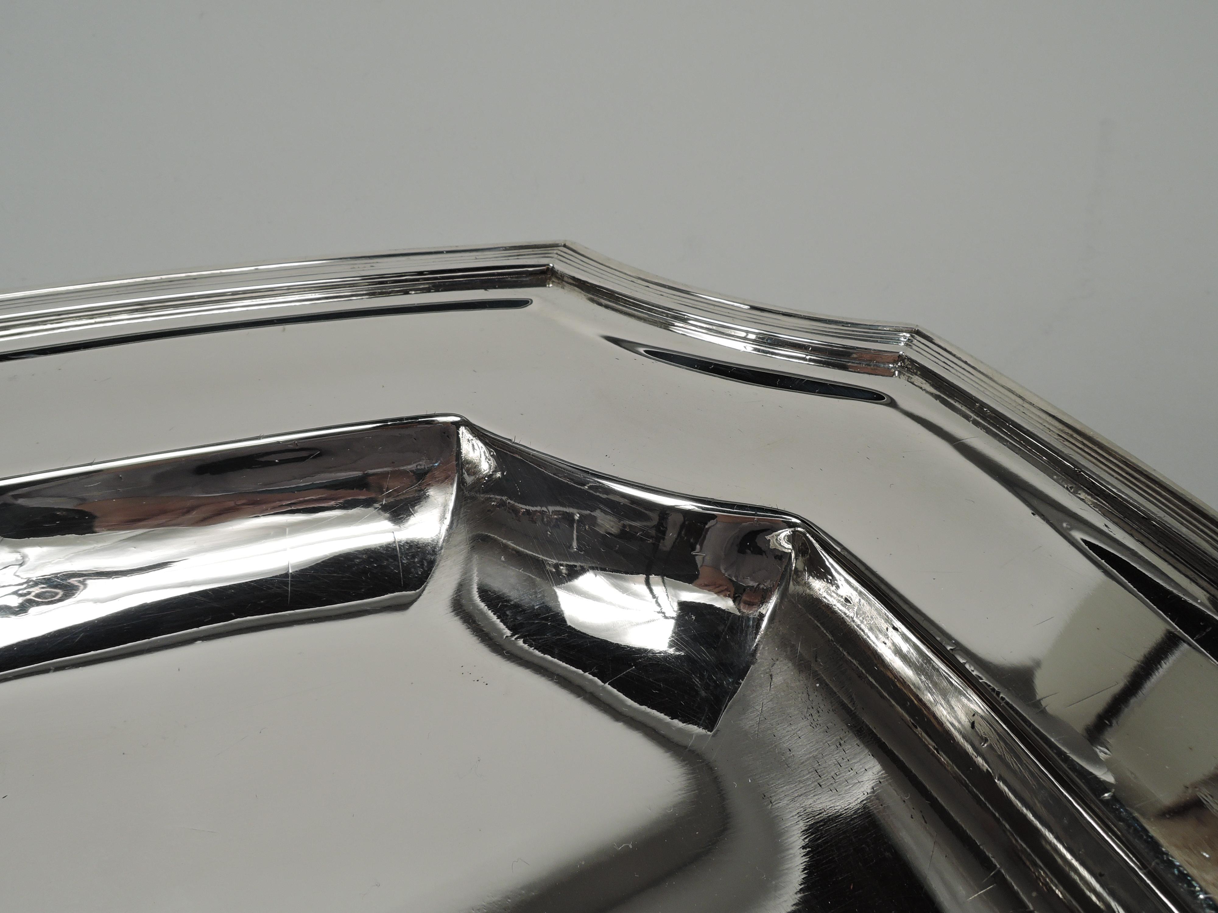 Hampton sterling silver serving tray. Made by Tiffany & Co. in New York, ca 1924. Rectangular with curved sides and concave corners. Deep well, wide shoulder, and reeded rim. Fully marked including maker’s stamp, pattern no. 20372 (first produced in