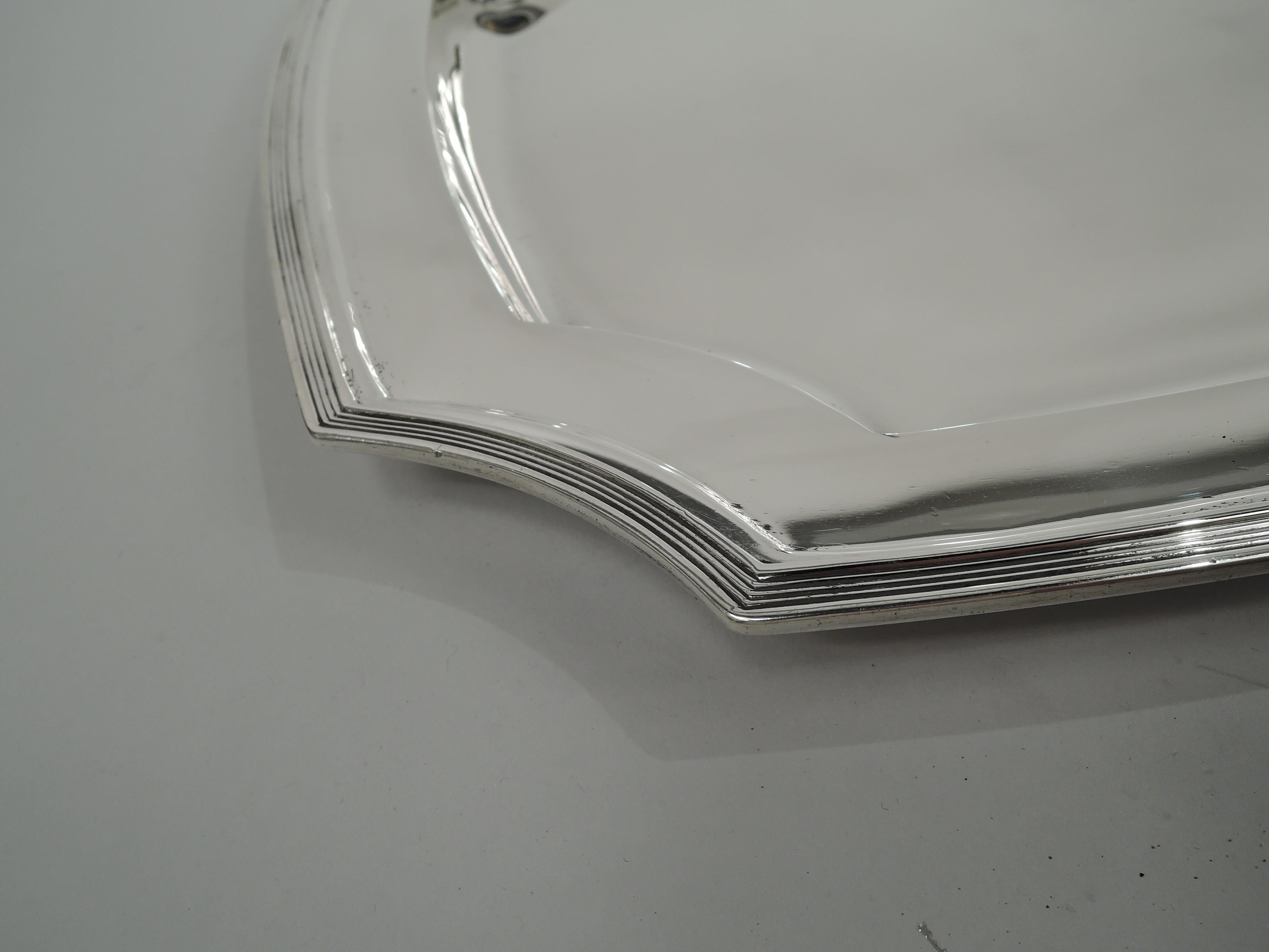 Hampton sterling silver serving tray. Made by Tiffany & Co. in New York, ca 1924. Rectangular with curved sides and concave corners. Deep well, wide shoulder, and reeded rim. Fully marked including maker’s stamp, pattern no. 20373 (first produced in