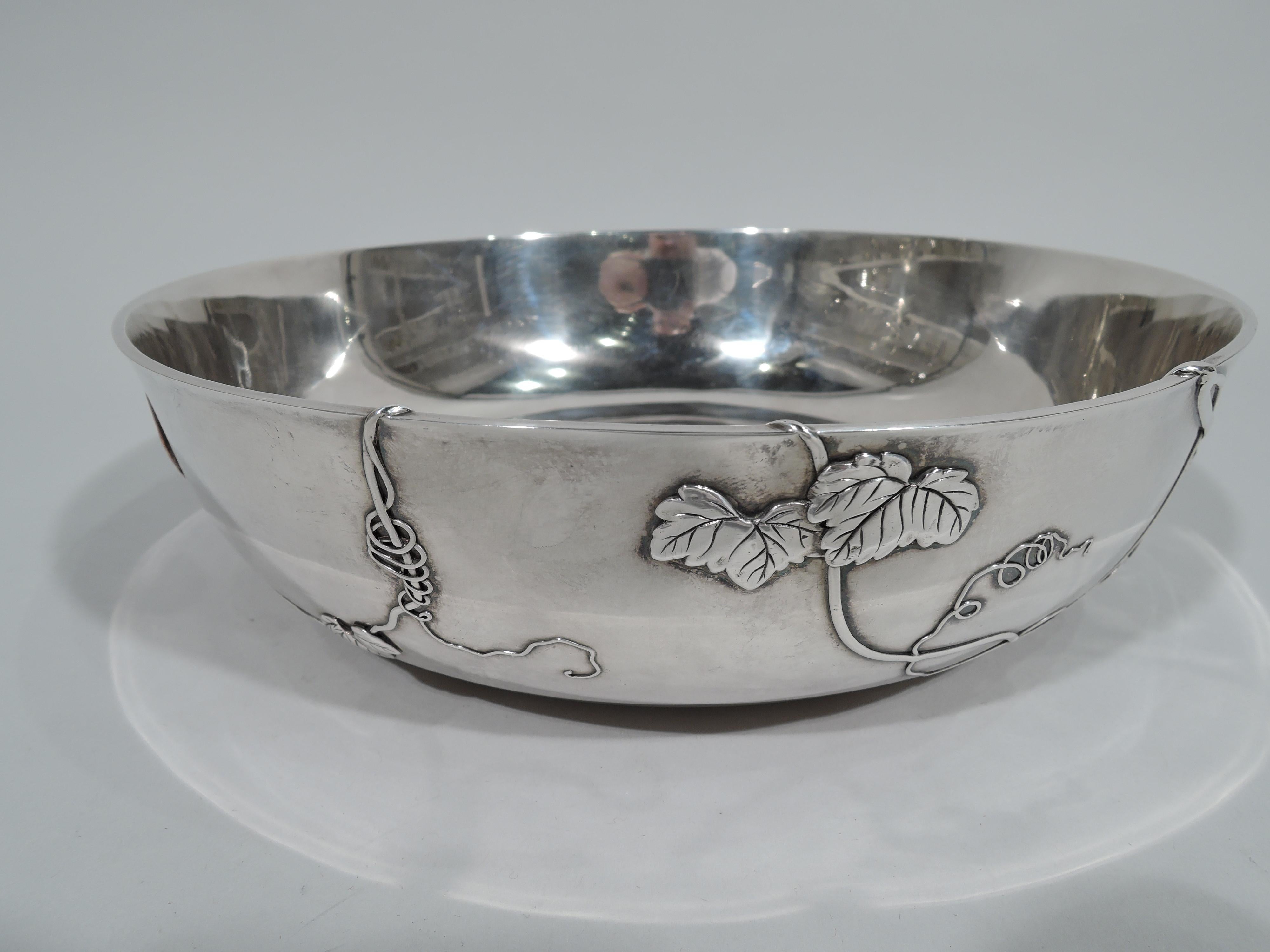 Japonesque mixed metal and sterling silver bowl. Made by Tiffany & Co. in New York. Round with curved sides. Applied to exterior are sinuous and curlicue leafy tendrils with butterflies, dragonfly, and grasshopper. Some spillover on interior as well