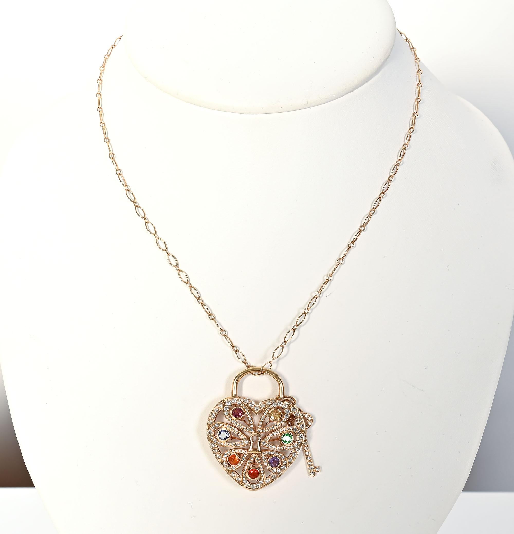 Finely detailed 18 karat gold heart pendant necklace by Tiffany with a variety of gemstones. Pear shaped elements are filled with round stones of: pink tourmaline; yellow and orange sapphires iolite; tsavorite and amethyst.  The center of the heart