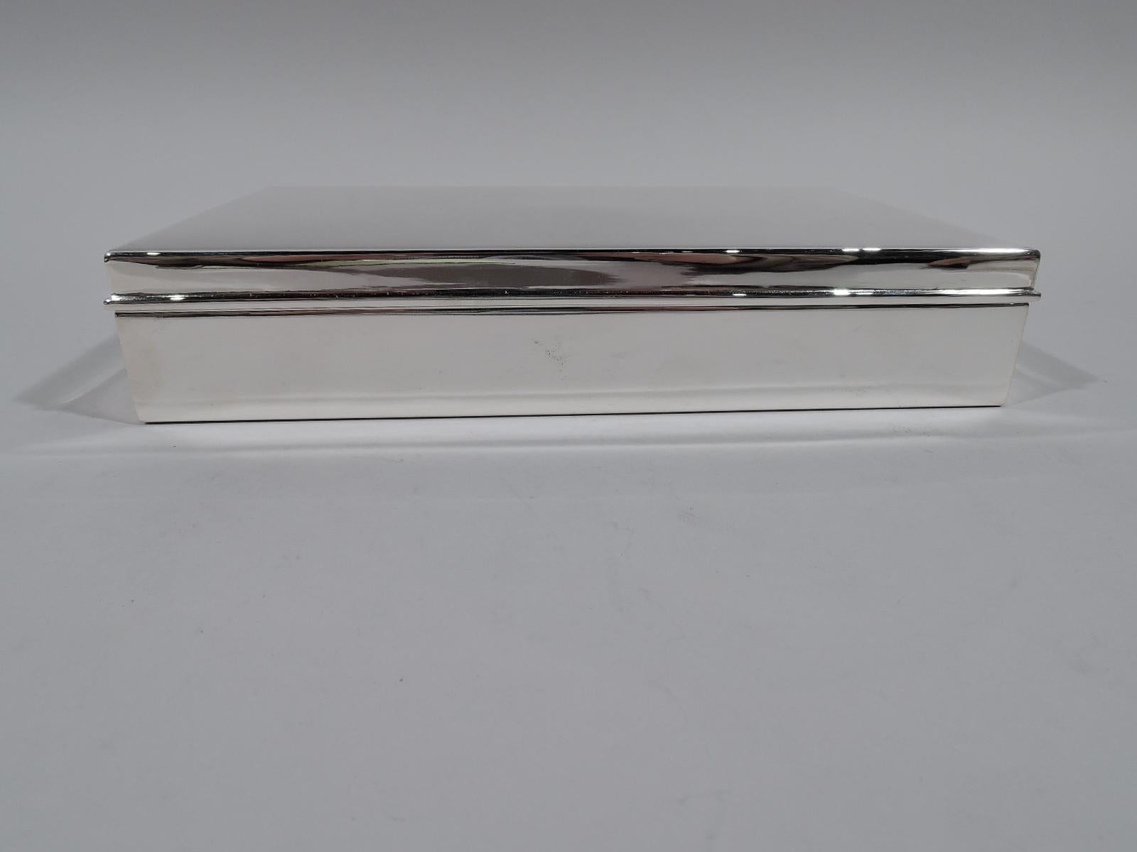 Large and heavy sterling silver desk box. Made by Tiffany & Co. in New York. Rectangular with straight sides. Cover flat and hinged with molded rim. Box and cover interior cedar-lined and partitioned. Fully marked including pattern no. 22358,