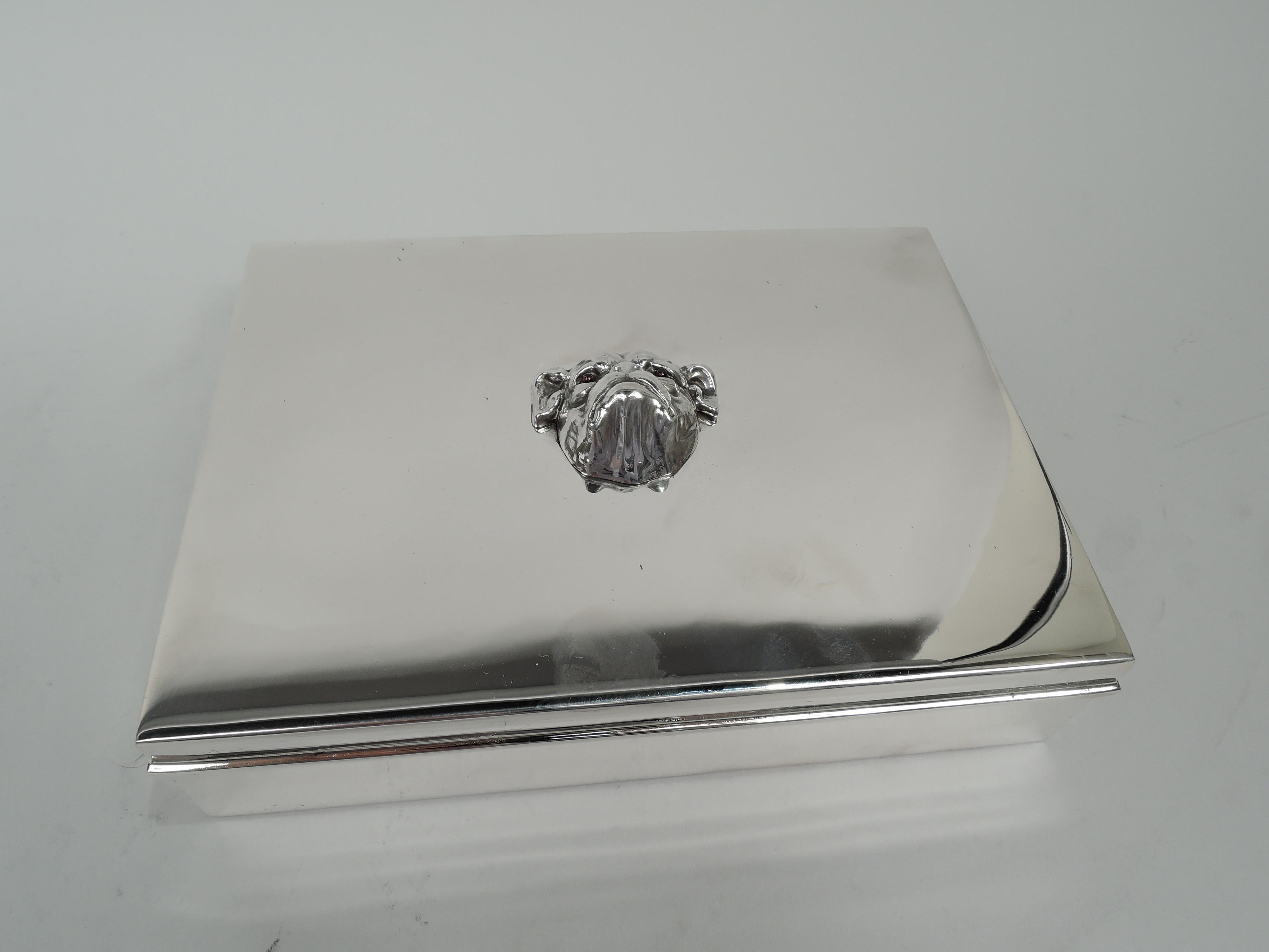 Large and Modern sterling silver box. Made by Tiffany & Co. in New York. Rectangular with straight sides. Cover flat and hinged with wraparound rectilinear rim; mounted to top is cast bulldog head with wrinkled brow, floppy ears, mournful frown, and
