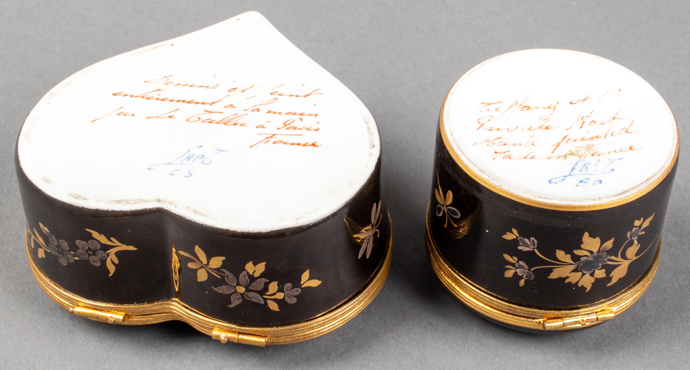 Two Le Tallec hand painted and gilt decorated black porcelain boxes, 1980s, probably from the Cirque Chinois pattern, one round and one of heart-form, both overall with Chinoiserie scenes and decorations, round box signed to base 